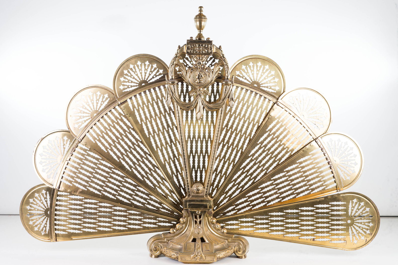 Expandable Brass Fan Style Fire Screen: Screen is expandable / collapsible and measures approximately 26"H and 52" wide when open. It is a solid brass fire screen.