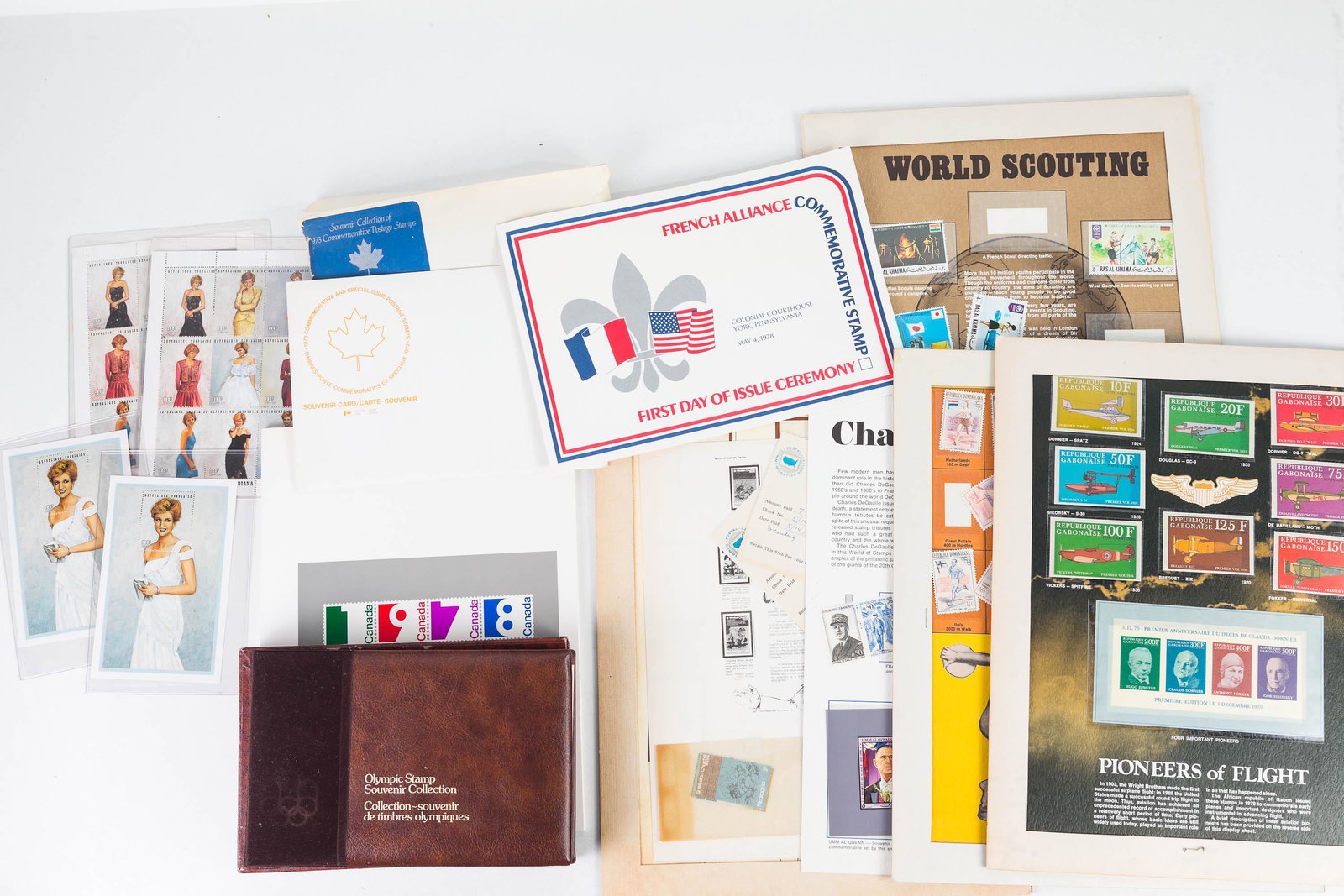 Canadian and World Stamp Collection: Lot includes World Scouting 1-page sheet, 17c Olympic Games, Charles DeGaulle 1-page sheet, French Pioneers of Flight 1-page sheet, Churchill 1-page sheet, 1978 Canadian stamp book, 1982 Canadian Olym
