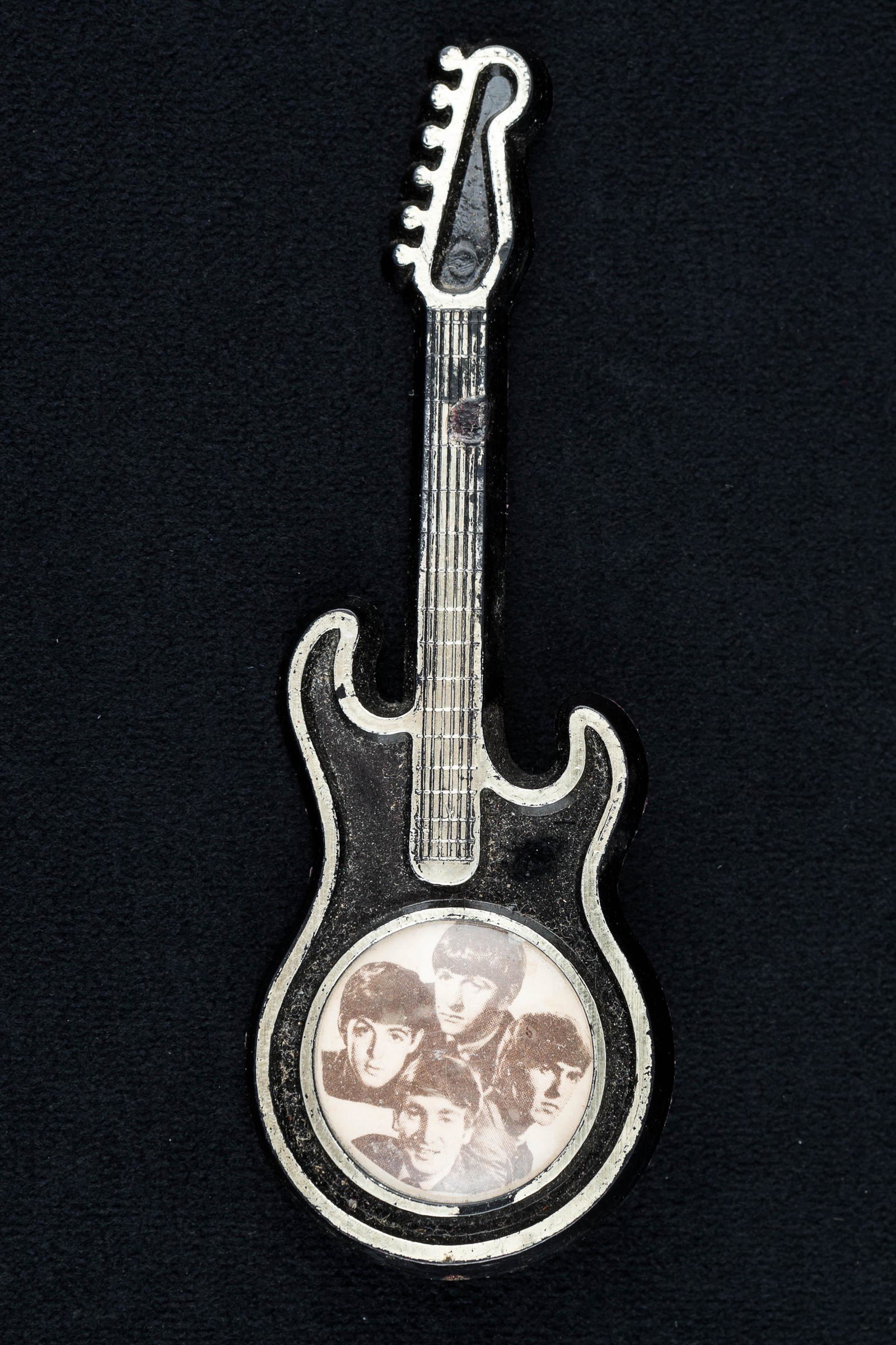 Vintage Beatles Pin: Guitar shaped original Beatles pin with all 4 Beatles in center in black and white.