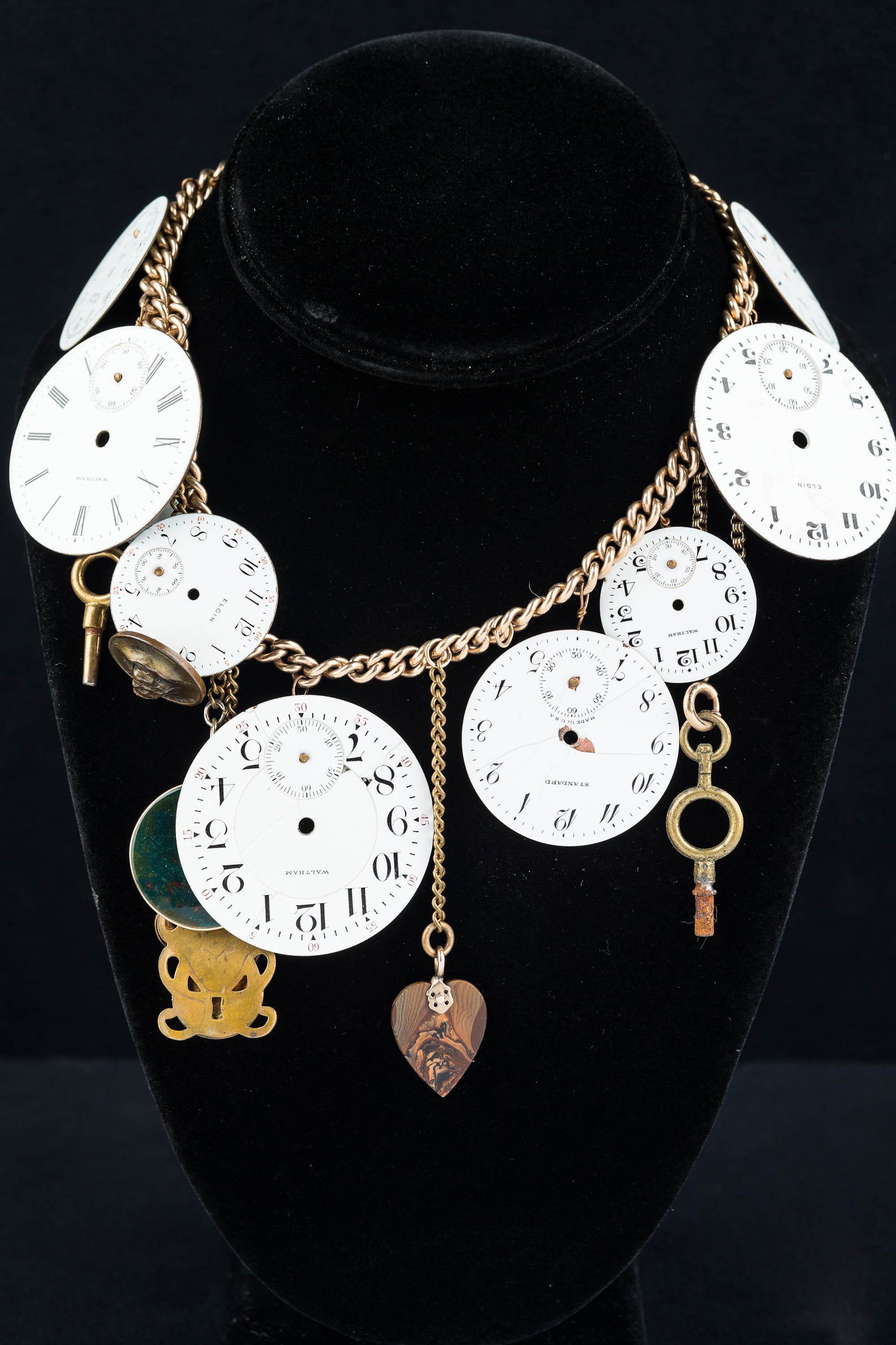 Artisan Watch Necklace: Item consists of several white enamel watch faces, a blood stone charm, a gargoyle, and carnelian charm, antique watch keys, and more.