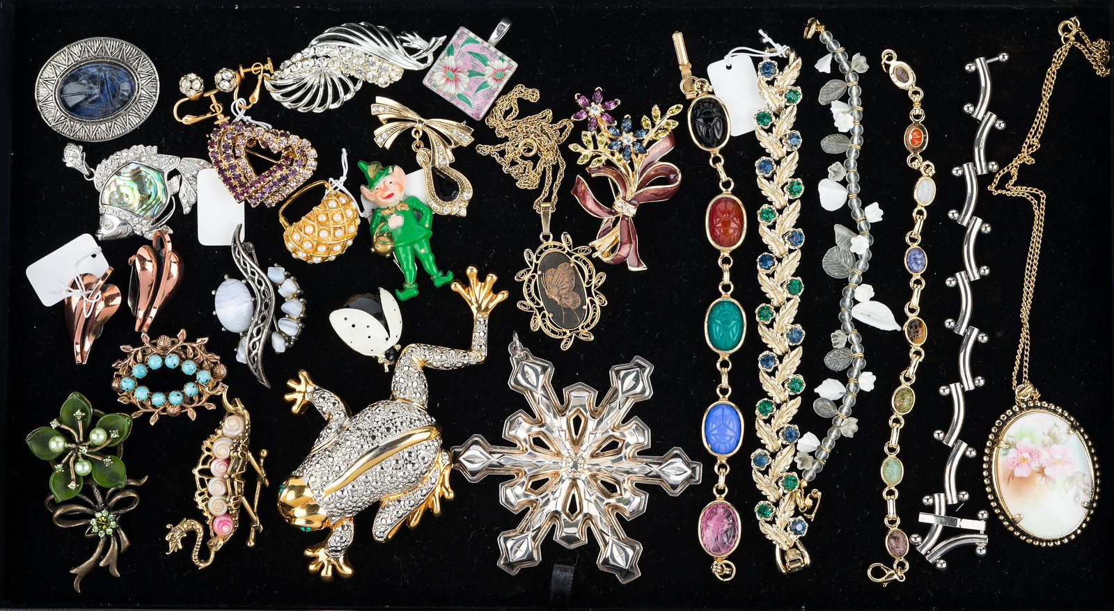 Brooches and Bracelets: Lot includes a large frog brooch, a dragon ship brooch, a hinged fish pendant with abalone, triple heart with multicolor rhinestones, two scarab bracelets, snowflake, leaf bracelet with colorful rhine