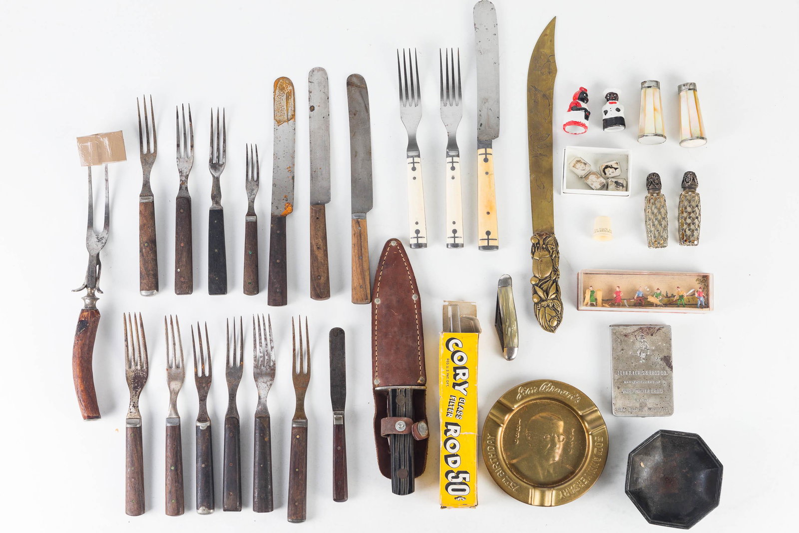 Vintage Cutlery and Eclectic Mix: Lot includes a selection of Civil War era wooden handle flatware, an unmarked sheath knife, letter opener with scarab, decorative salt and peppers, an Imperial folding knife, miniature framed photogra