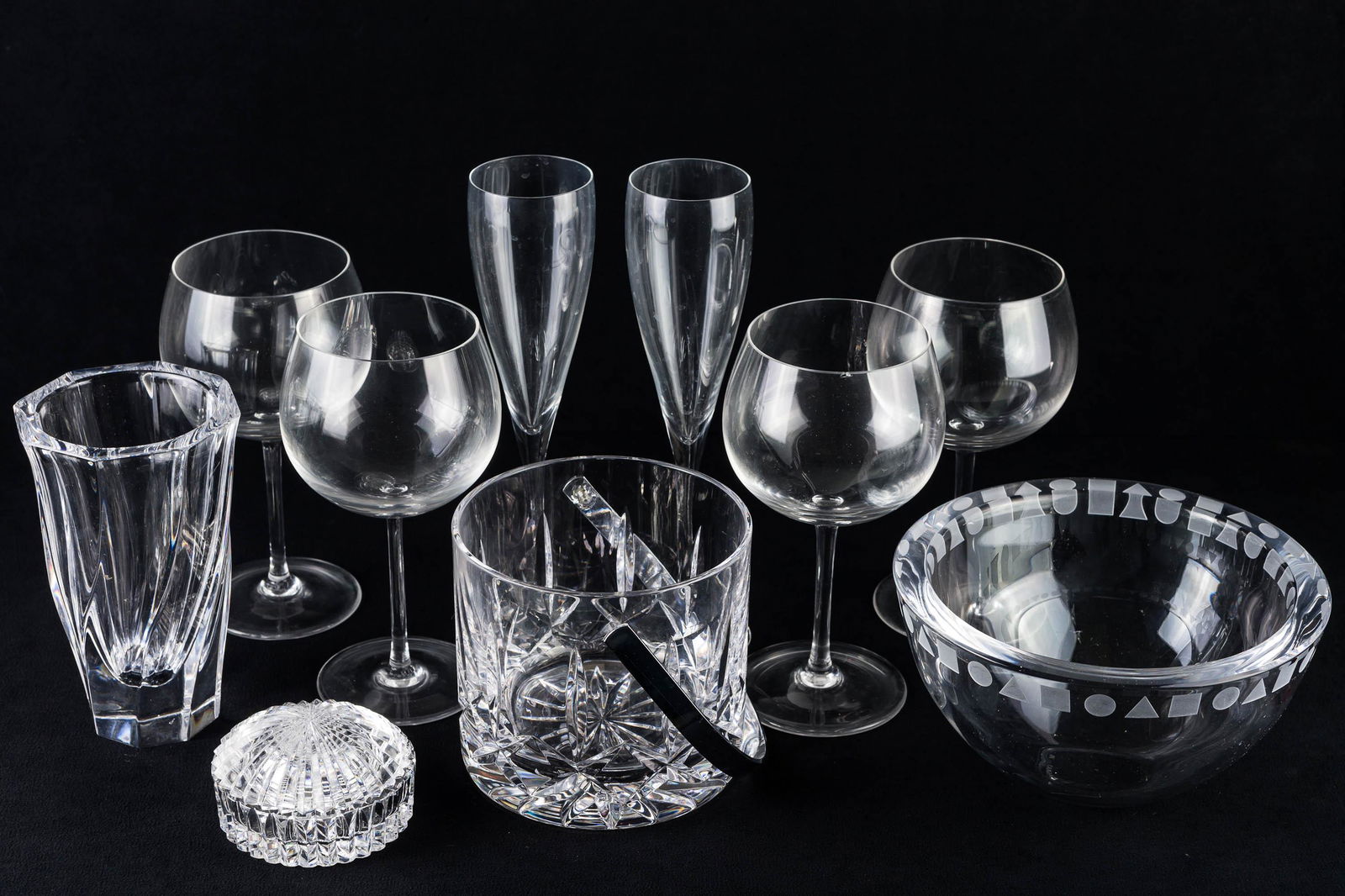 Signed Crystal Grouping: Lot includes an Orrefors vase (6"H), 2 Orrefors champagne flutes, 4 white wine glasses with T marking, a small covered crystal jar, a crystal ice bucket marked Atlantis, and a decorative crystal bowl