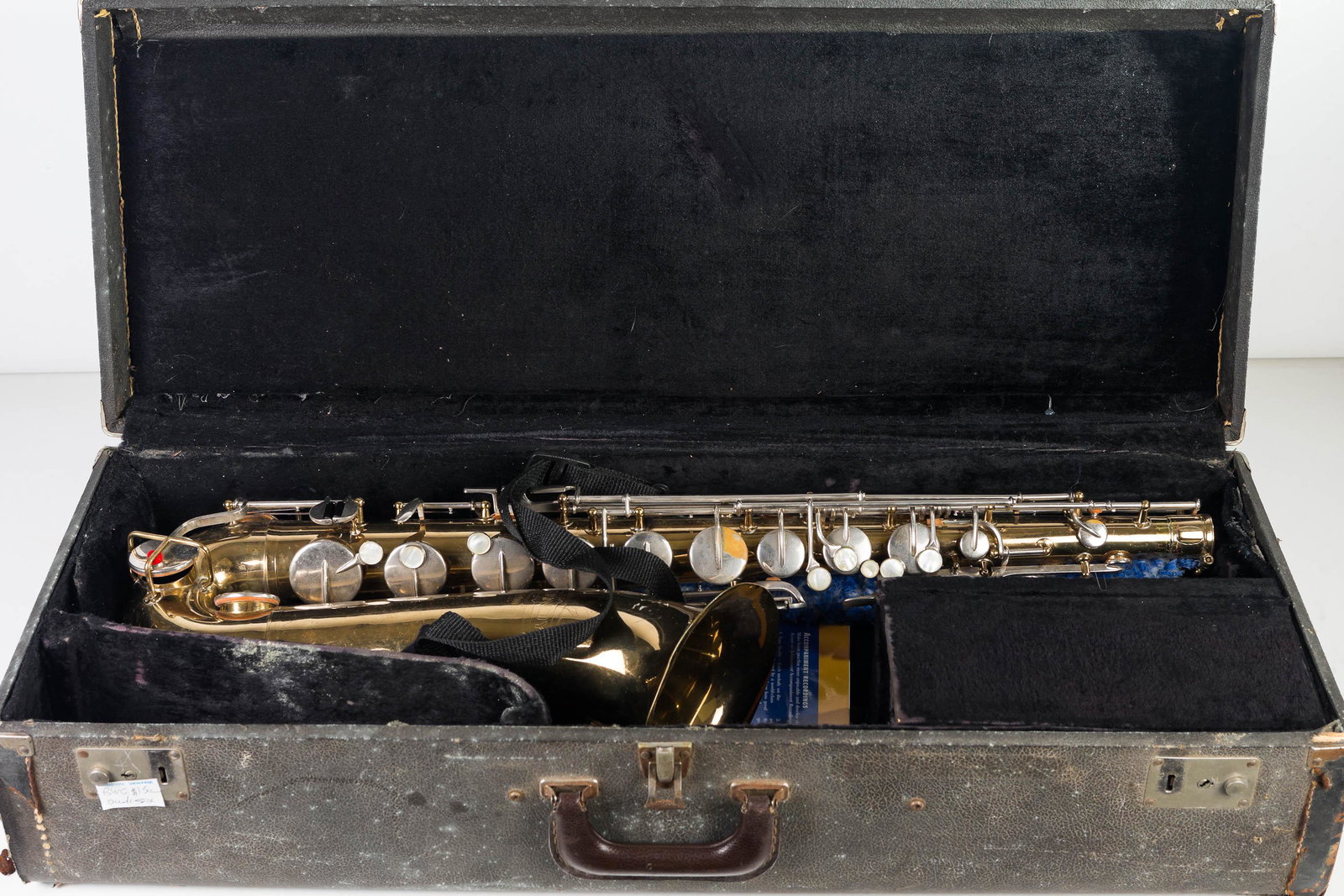 Bundy Tenor Saxophone: Saxophone measures approximately 32"L. Overall clean surface, appears to retain its pads. Marked Bundy Selmer USA. Serial No 534587. Small dent at serial number. Item comes in hard shell case (exterio