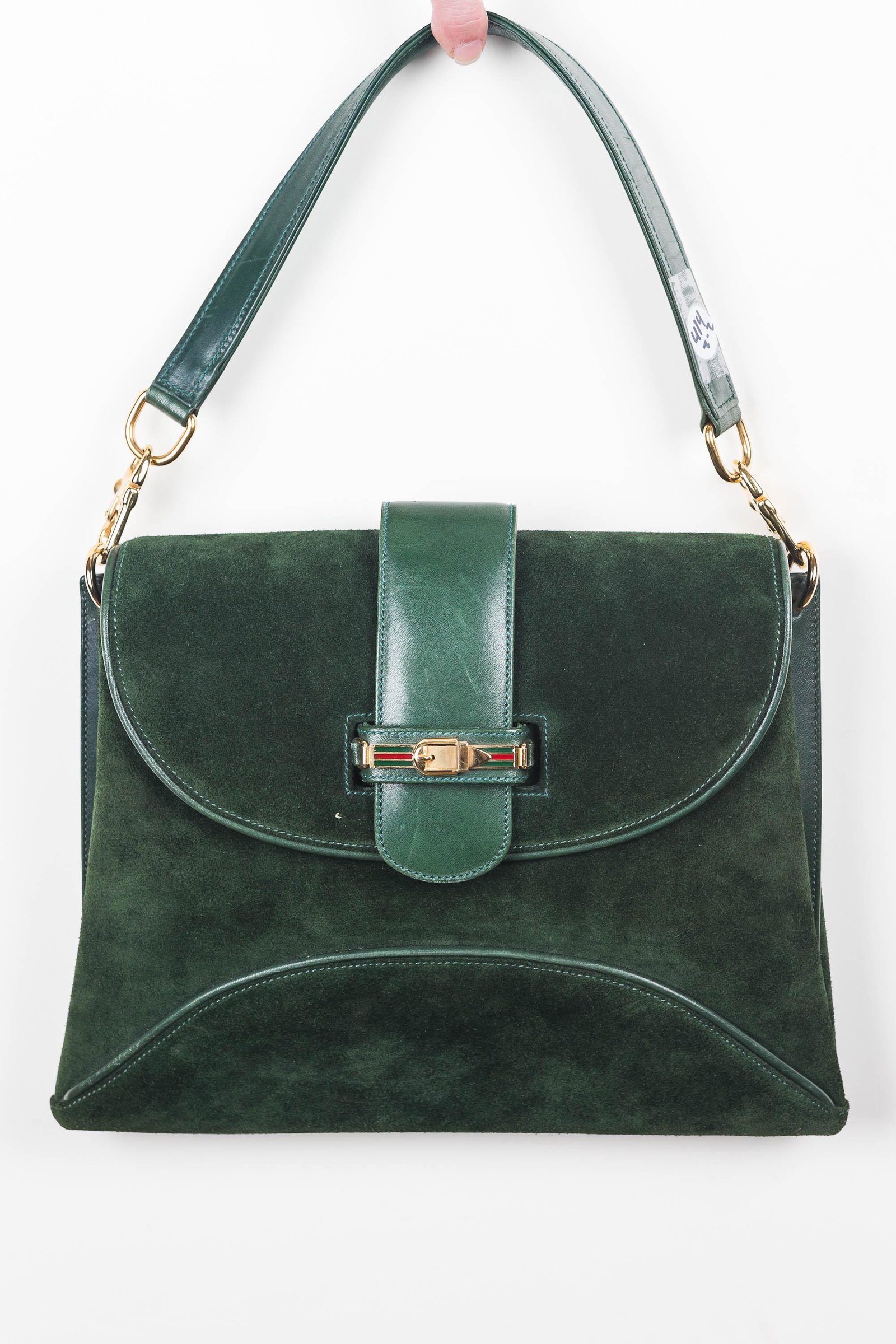 Gucci Suede Envelope Purse: Green suede Gucci purse with leather accents. Purse has detachable 14" leather strap, envelope style look with leather piping, pleated expandable sides, leather slide through closure, one inside zippe