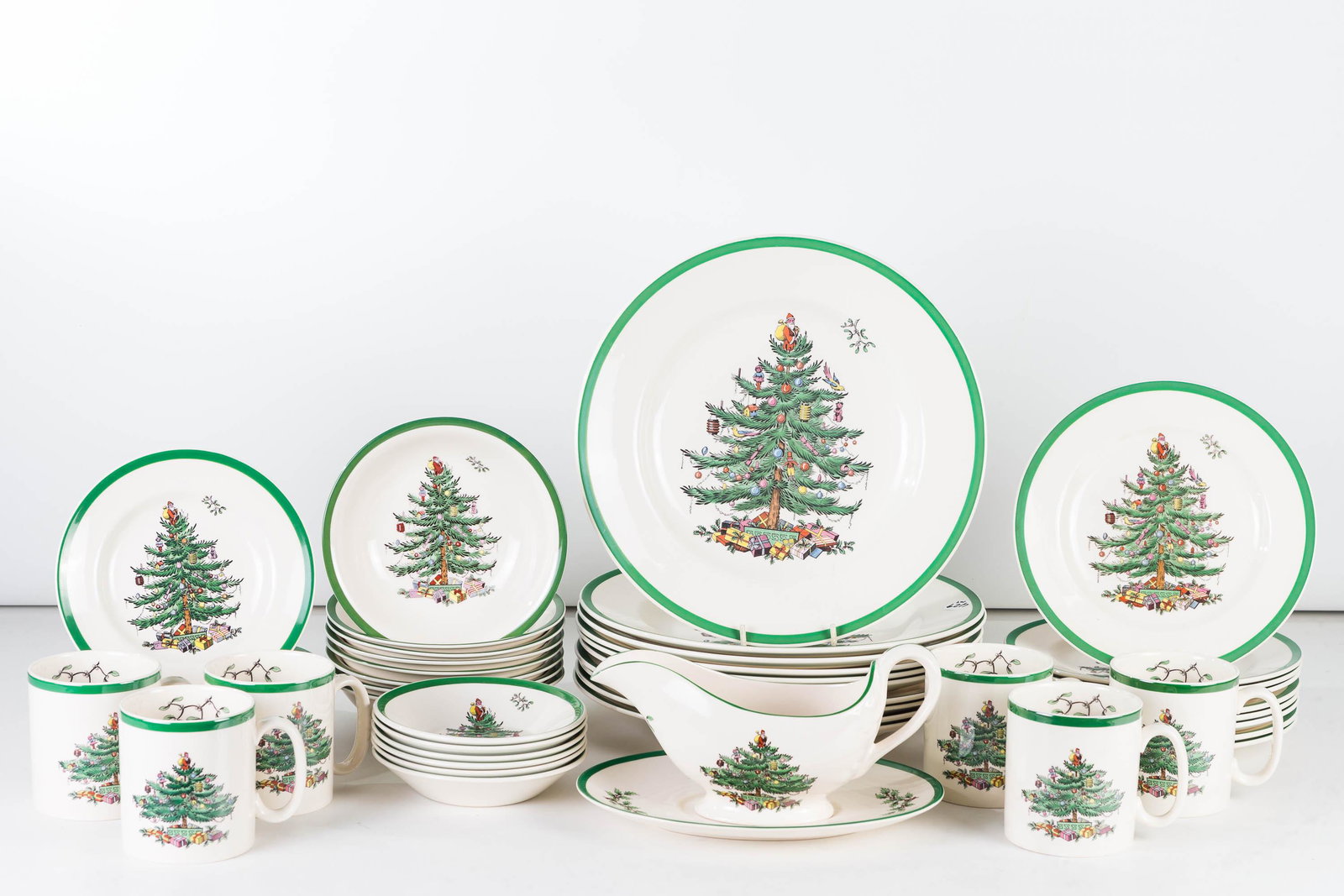 Spode Christmas Tree Dinnerware: Lot includes 10 10.5" dinner plates, 9 7.5" salad plates, 6 ice cream bowls, 8 small soup bowls, 6 coffee mugs, 7 underplates, and a gravy on tray.
