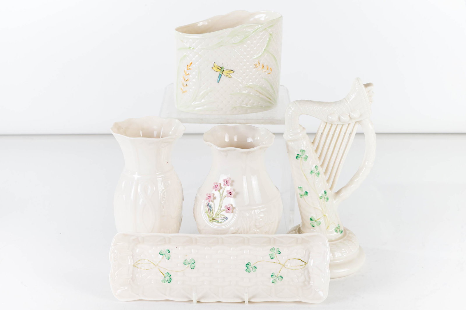 Belleek Figural Harp and Related: Lot includes a Belleek figural harp with brown mark (8.5"H), a Belleek Birds of Affection vase (2001), a Visitor's Center Exclusive Water Elves vase, a pen tray with blue mark, and a pen holder vase w