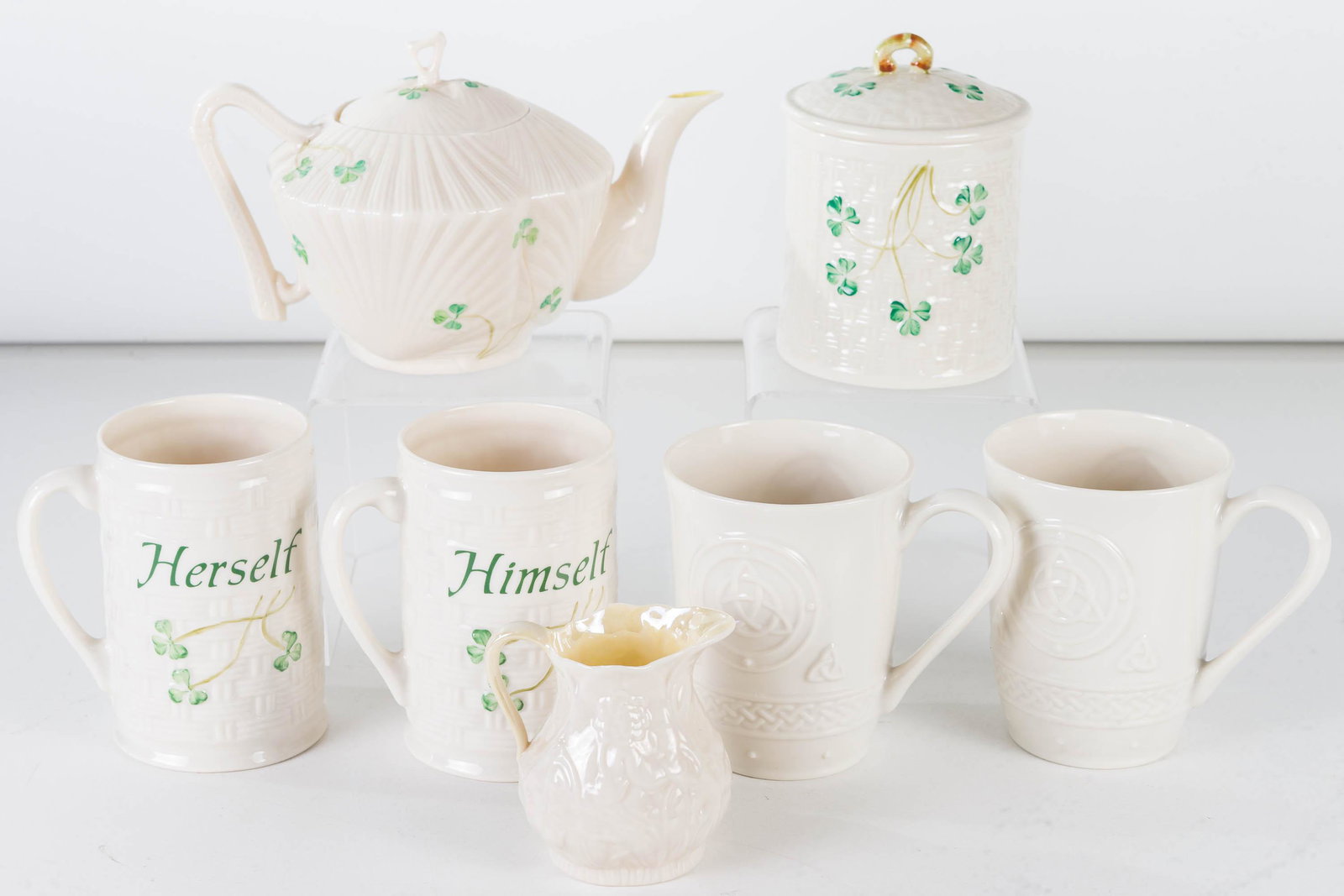 Belleek Teapot and Related: Lot includes Belleek teapot (5"H) with green mark and registry number, covered Belleek jar with brown mark, Himself and Herself Belleek coffee mugs, a pair of Belleek coffee mugs with eternity design,