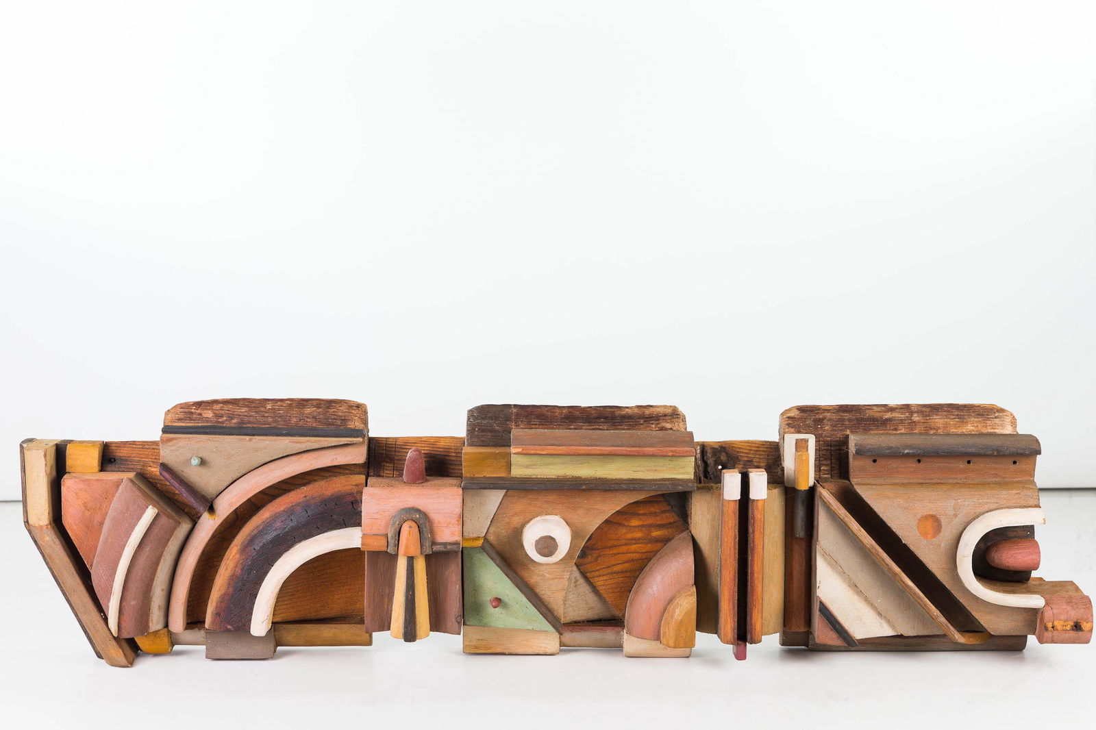 Wooden Post Modern Design Sculpture by Dan Miller: Item measures approximately 30"L x 7.5"W. Multi-layer geometric mid-century modern style wall sculpture. Appears to be missing one small accent piece, and it has a re-glue at that section on one end.