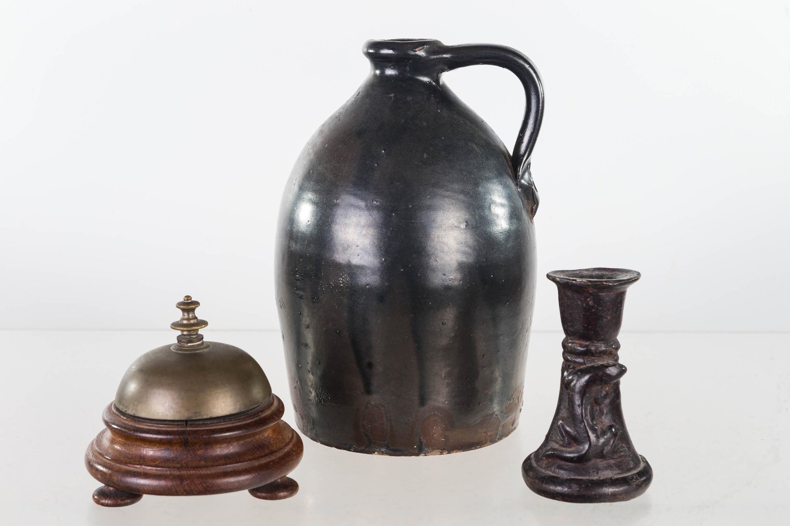 Mixed Country Grouping: Lot includes a salt glaze shoulder jug (9"H) in overall good condition, a brass and oak store bell, and 19th C cast iron holder with salamander on side.