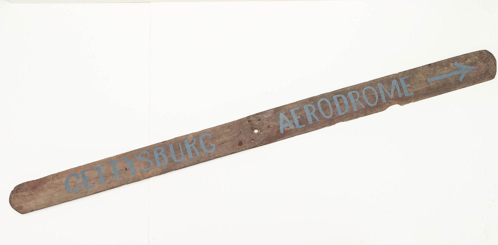 Gettysburg Aerodrome Advertising Propeller: Item measures approximately 70.5"L. Wooden propeller with handwritten Gettysburg Aerodrome and arrow. Propeller has one chunk out of blade, dates to early 20th C.