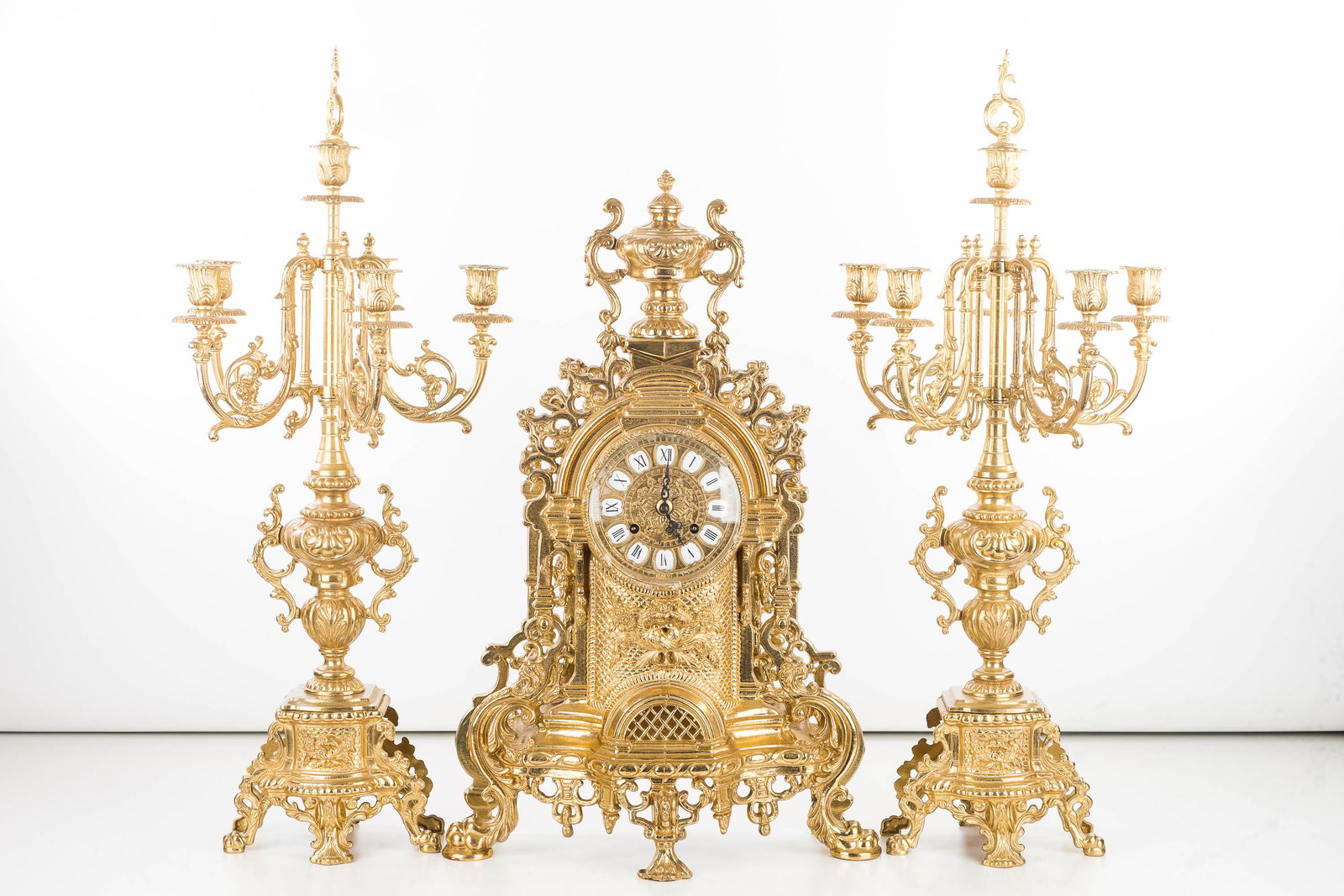 Ornate Brass German Gondola Set with Clock: Clock measures approximately 23"H and gondolas measure approximately 27"H. All are constructed of ornate brass, clock has porcelain numeration on face, glass bezel has hairline crack and has been re-s