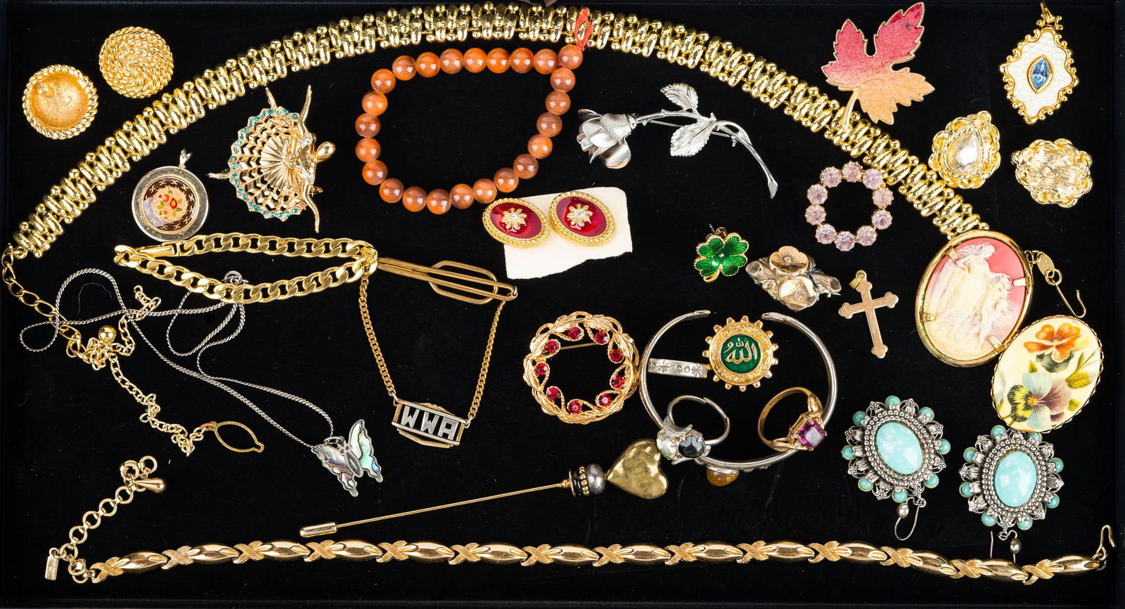 Mixed Costume Jewelry: large gold tone necklace marked Trifari, gold tone bracelet, gold tone knotted style necklace marked Monet, ballerina pin, Roman style cameo, rhinestones, and other jewelry.