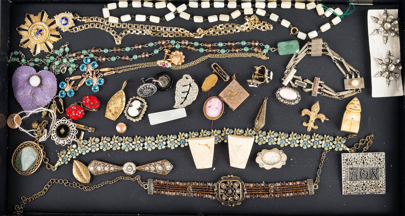 Victorian Style Costume Jewelry: floral necklace with blue rhinestones, pink and black cameos , both with brass backs, Masonic style necklace, carved Billiken figure, rhinestone earrings, vintage pins, and lockets.