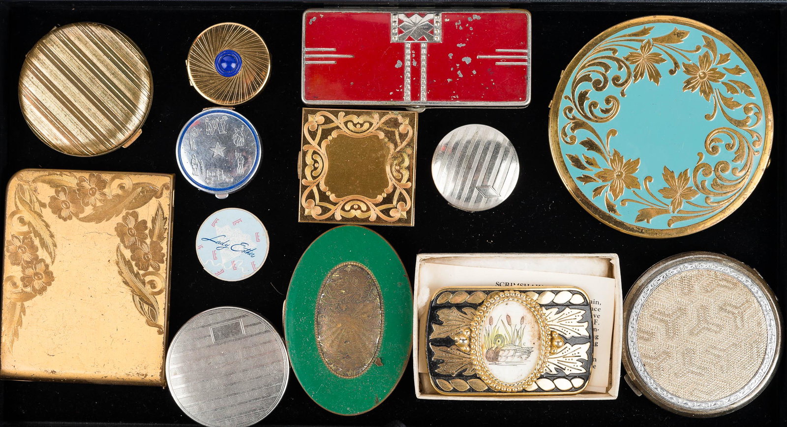 Vintage Compacts and a Buckle: gold and black buckle with scrimshaw duck, large round and blue floral compact marked Rex 5th Avenue, small round perfume pack with blue enameled stone marked Tangee, round gold tone compact marked Me