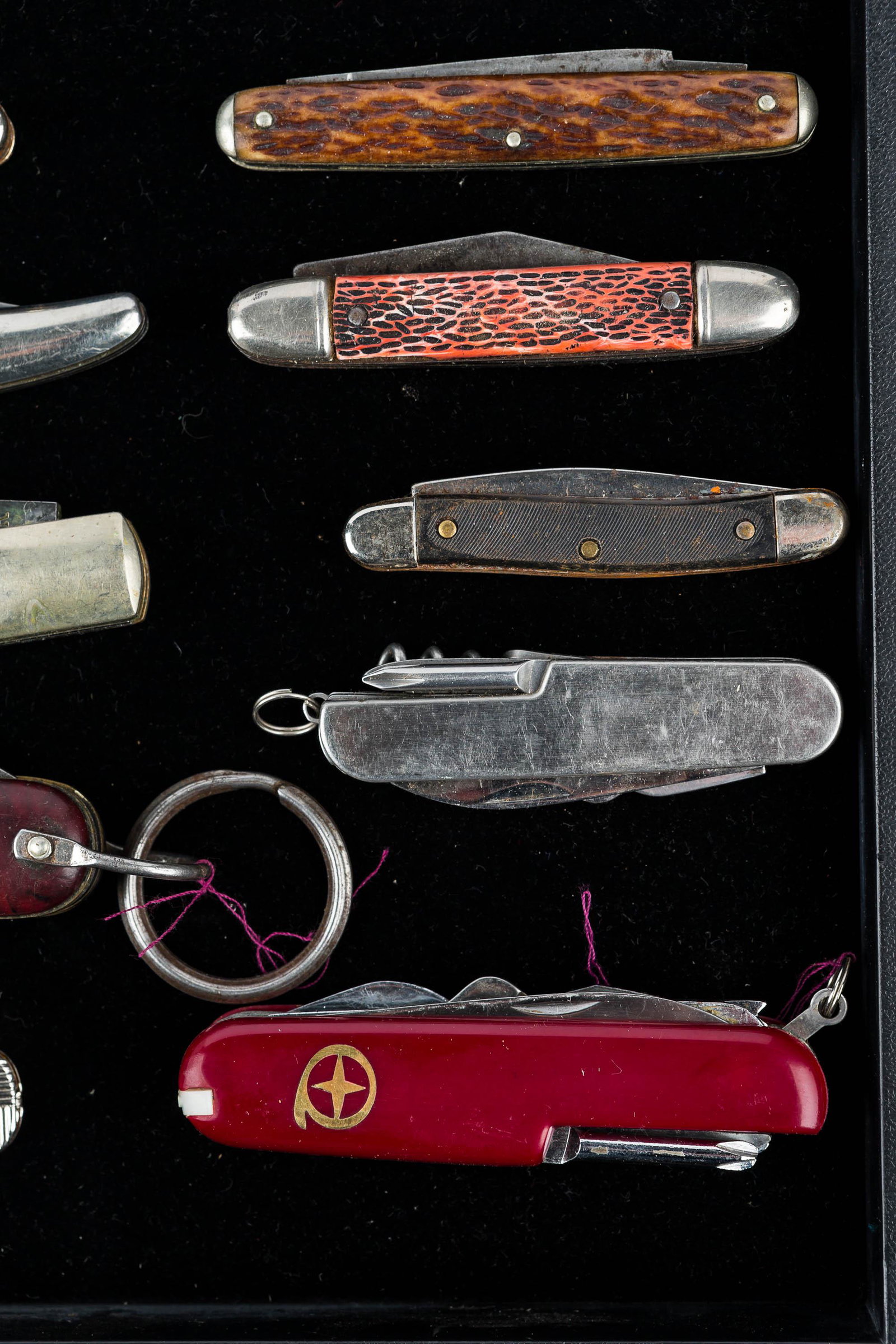 Collection of Folding Knives: 15 folding knives including Swiss Army style knife, an Ulster USA folding knife with brown handle, spring loaded folding knife and various others.