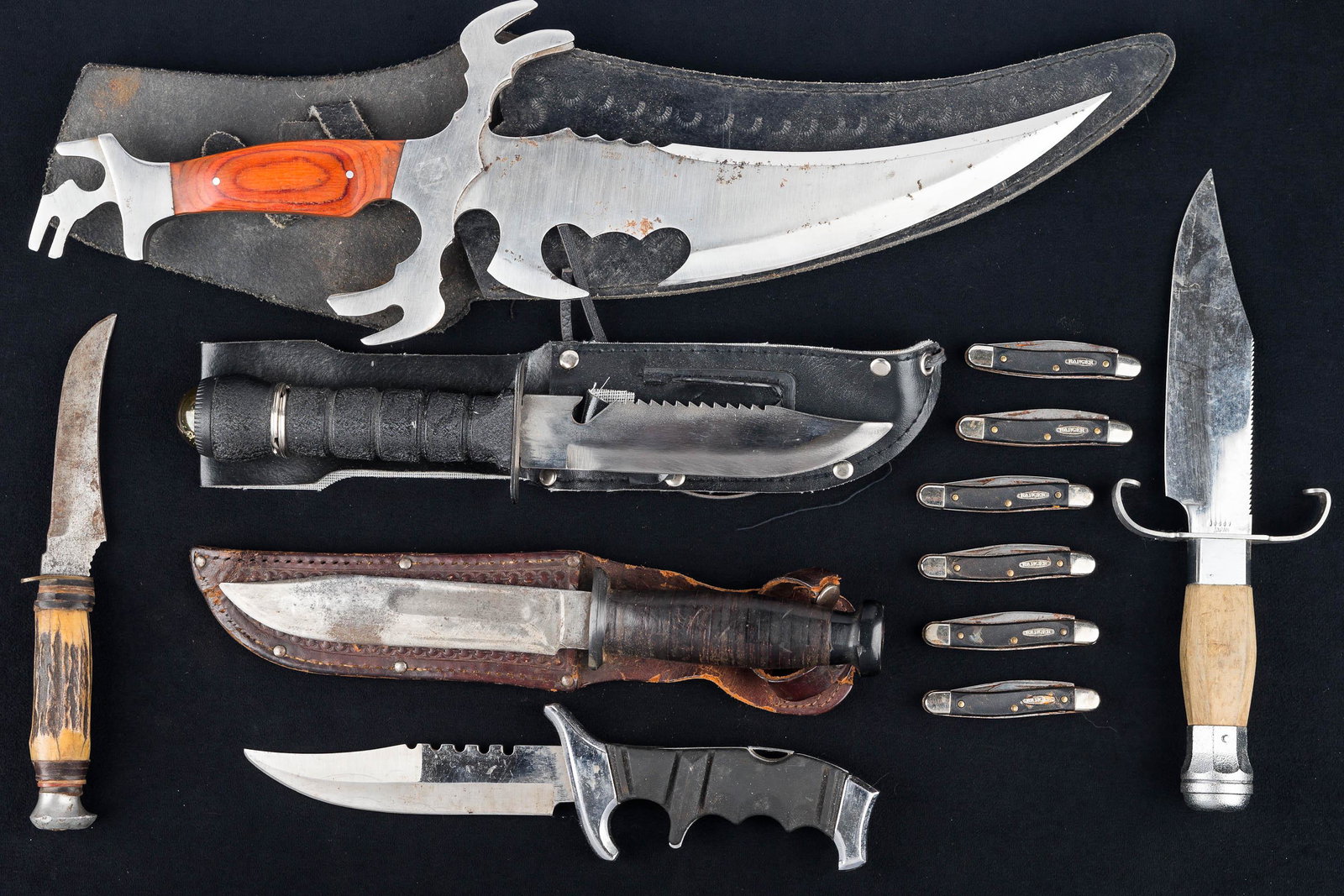 Sheath and Folding Knives: Six matching Ranger folding knives, various hunting knives, survival knife with compass and sheath, WWII era hunting knife with no markings and leather sheath, and a large stylized knife (17"L) marked
