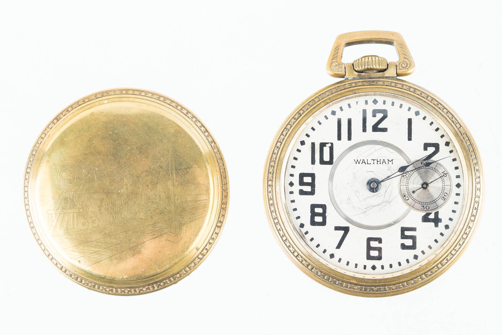 Large Waltham American Pocket Watch: Pocket watch has second hand on right side of face. Item is marked American Waltham Watch Co., 15 Jewel watch Movement No 13606994. Interior of back marked Keystone Base Metal, Case No 97385.