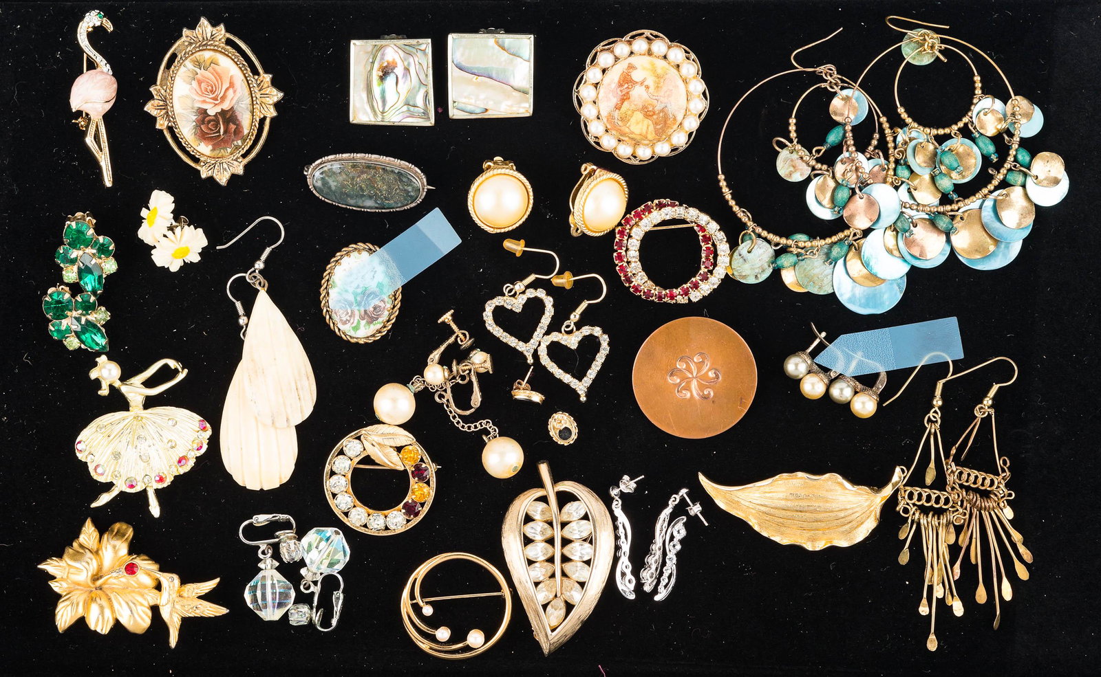 Designer and Other Costume Jewelry: an Alan Jay gold tone leaf pin, a Monet brooch with hummingbird and red stone, a Carla round pin with clear and colorful rhinestones marked gold filled, round Monet pin with three faux pearls, a pair 