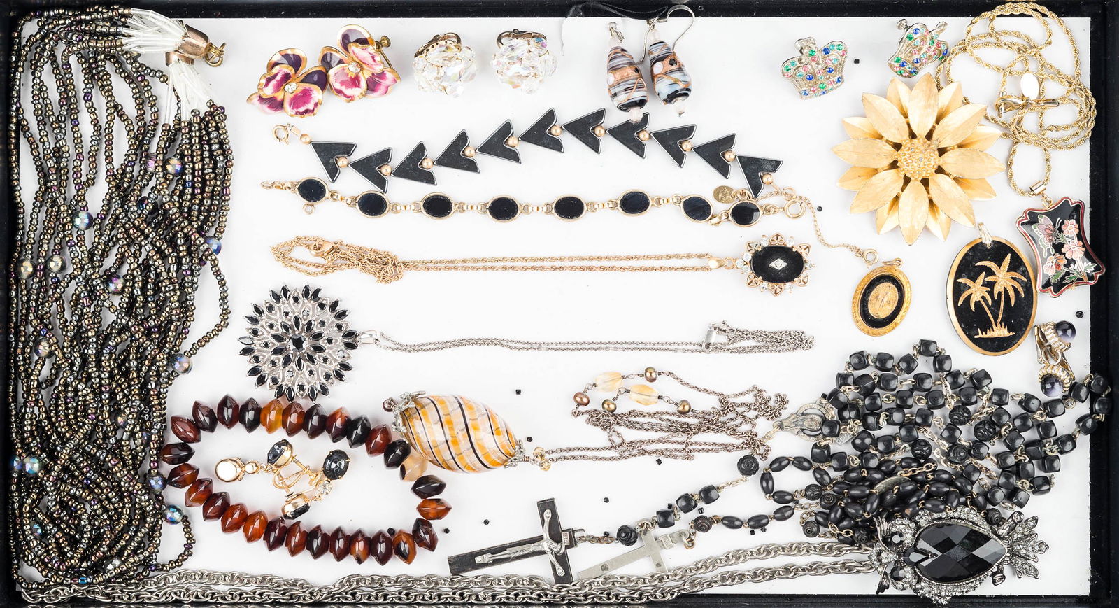 Mixed Costume Jewelry Grouping: geometric hematite bracelet, Worthington enameled pendant on chain, rosaries with cocoa beads, large Sarah Coventry sunflower brooch, delicate onyx bracelet marked Cassell gold filled, various earring