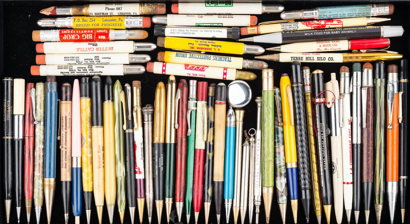 Advertising Bullet Pencils and Pens: a selection of advertising bullet pencils, advertising pens, two sweater pencils, and others. Most are vintage.