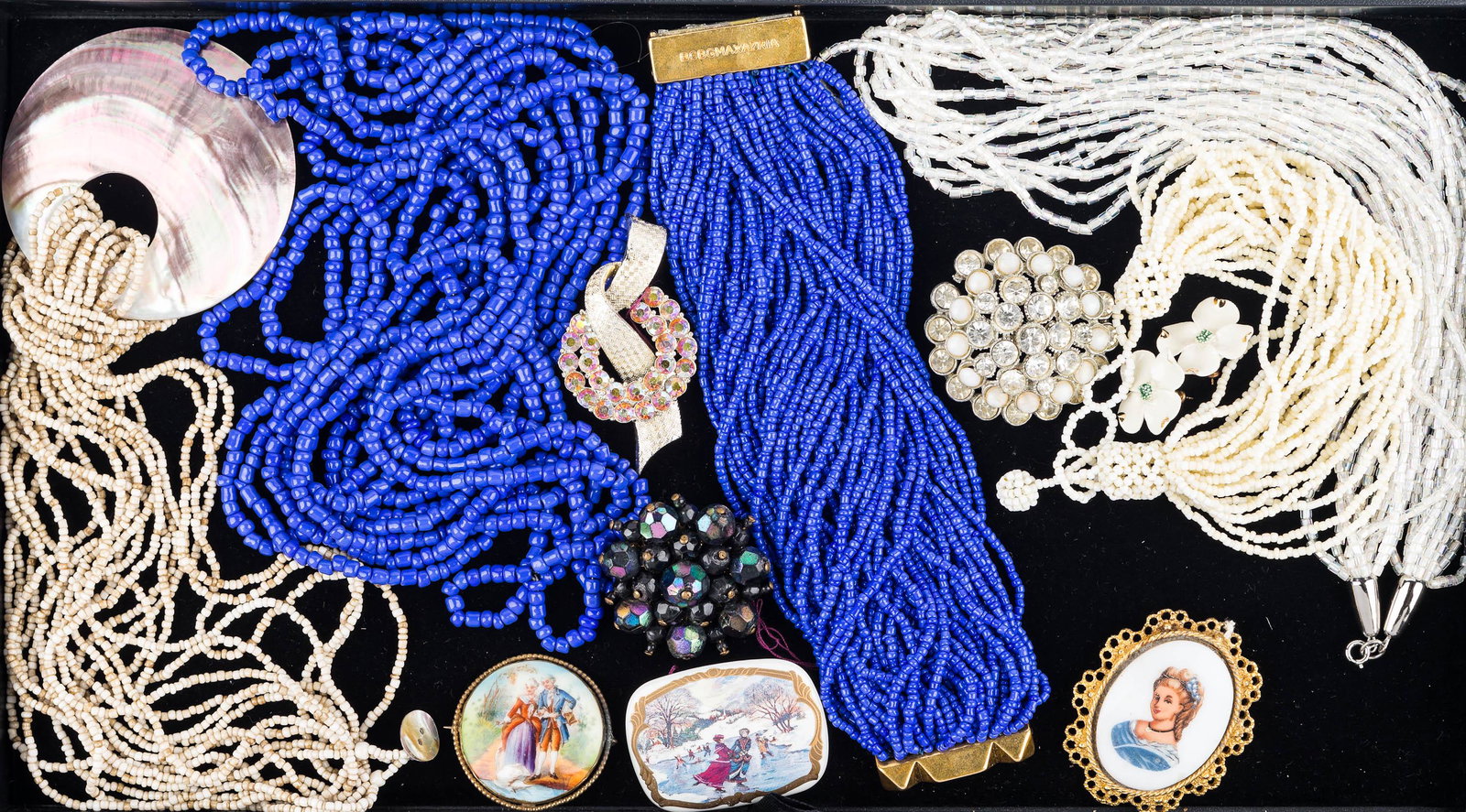 Beaded and Other Costume Jewelry: heavy blue beaded necklace marked bcbg max mara, 4 multi strand beaded necklaces, round brooch with clear rhinestones and faux pearls, bow tie brooch with aurora rhinestones, Austrian brooch with carn