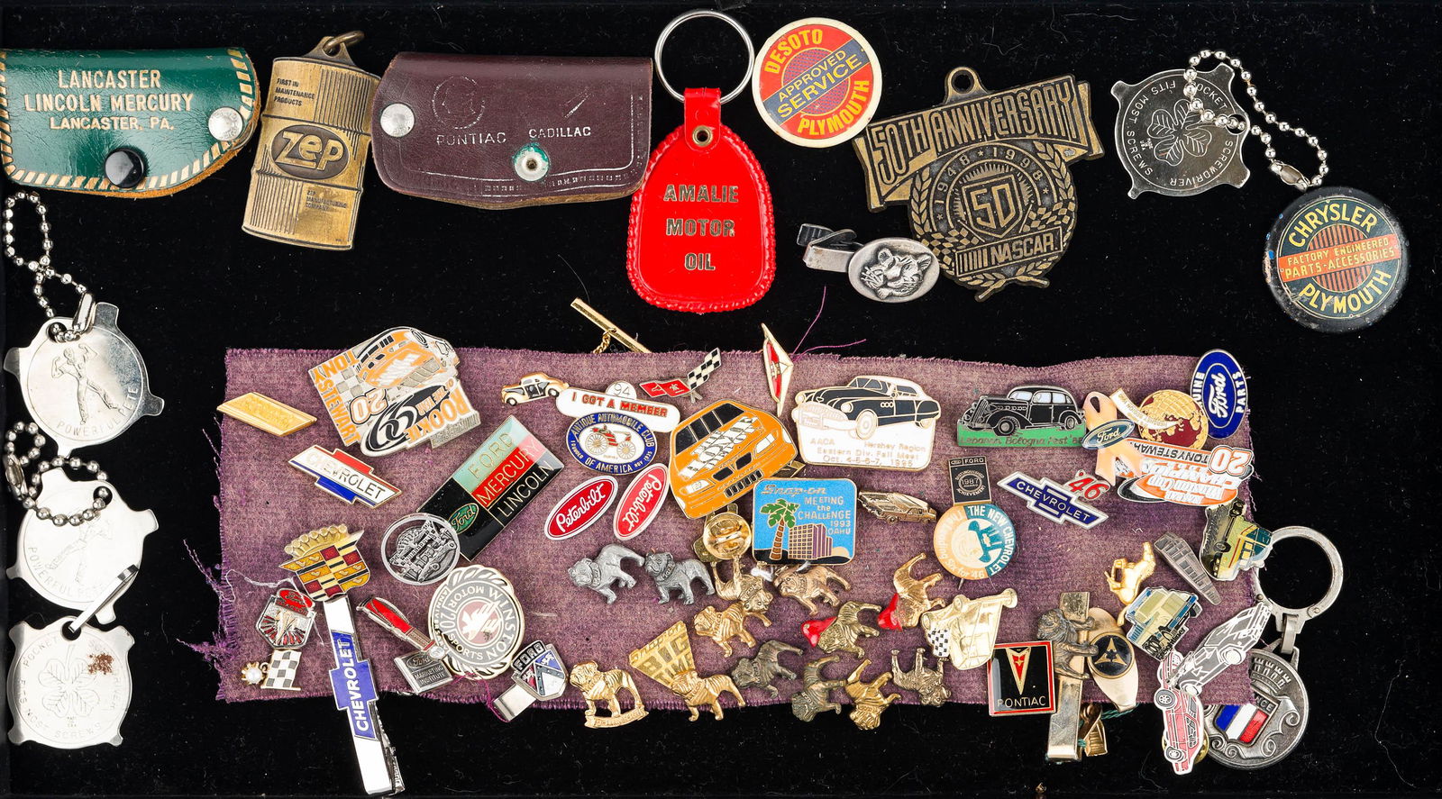 Auto and Truck Lapel Pins and Related: a large selection of Mack truck bulldog lapel pins, various automotive company lapel pins, advertising keychain holders, and related items.