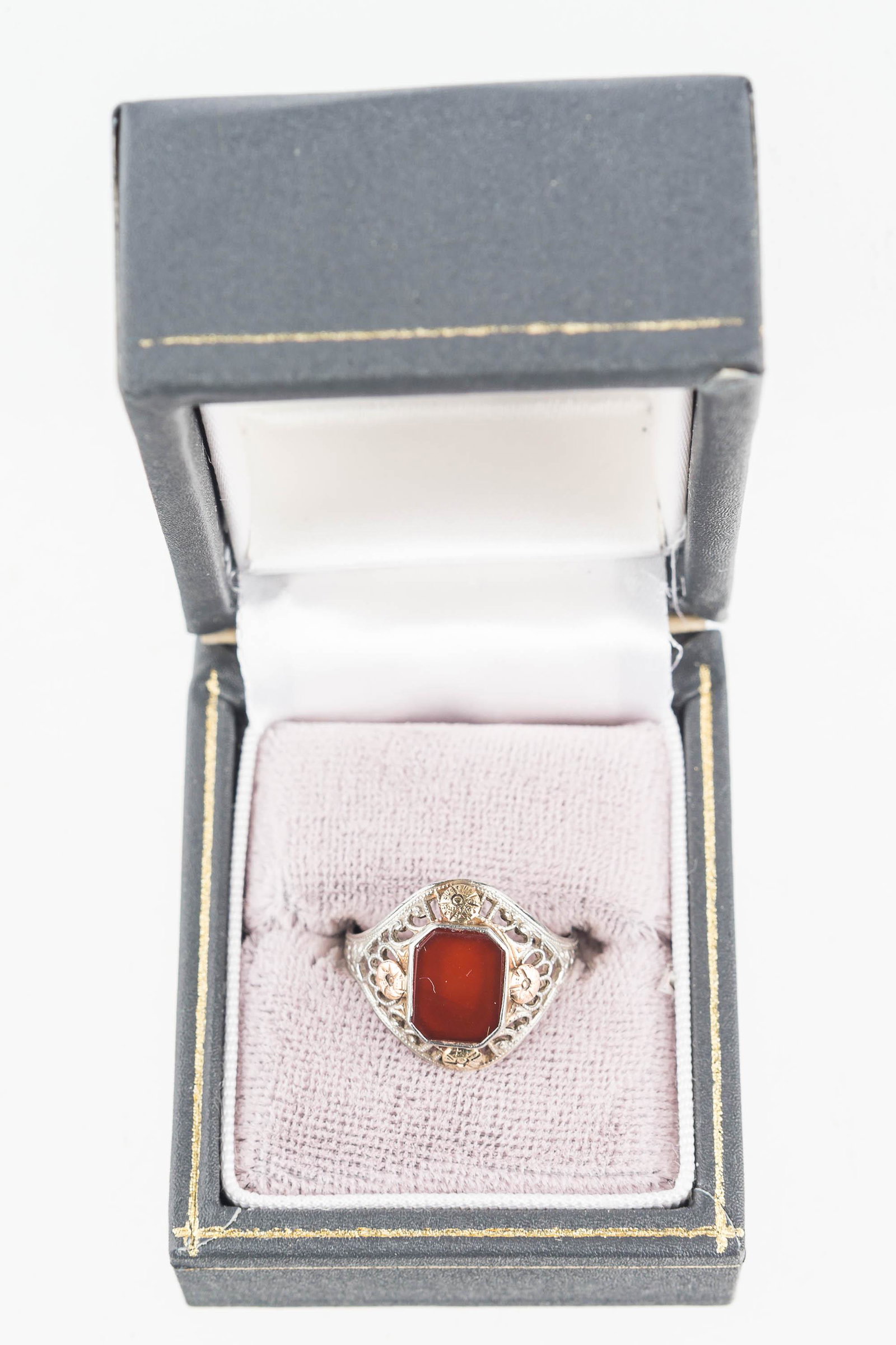 10K Gold Victorian Ring with Carnelian: White and rose gold Victorian ring with carnelian stone. Size 6.5. Carnelian stone is clean, filigree work is good and undamaged.