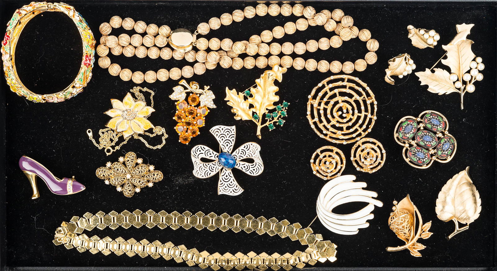 Designer and Gold Tone Jewelry: blue and white enameled bow tie brooch marked Trifari, white enameled brooch marked Terrino, calla lily brooch with obscure marking, gold tone and hand painted brooch marked Coventry, 3-piece leaf and