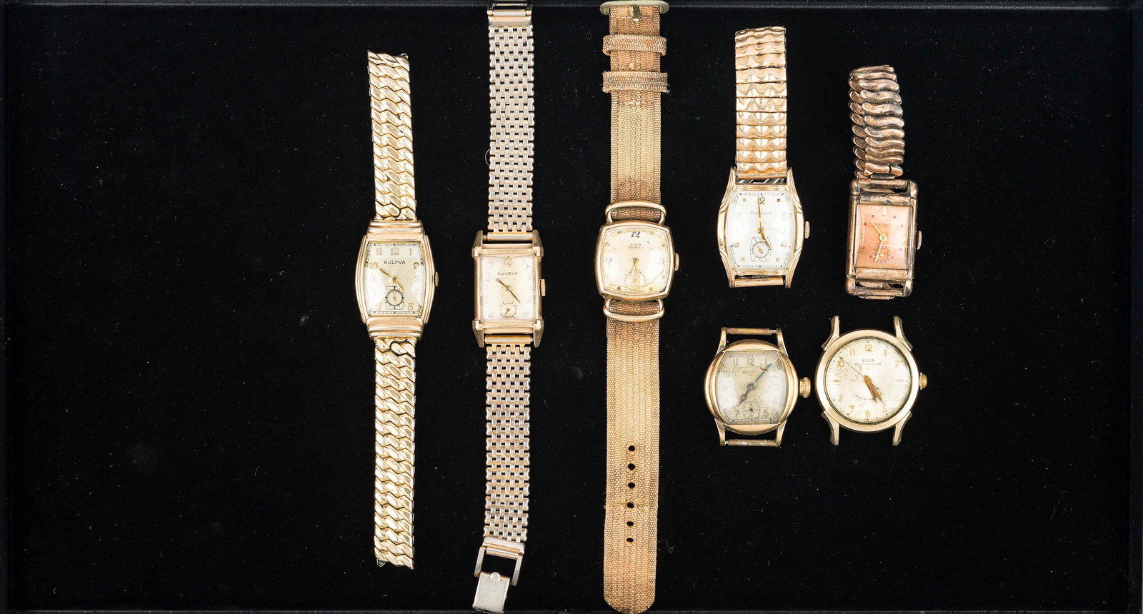 Mens Vintage Wrist Watch Grouping: Bulovas, Stetson with rectangular brass color face and band, Elgin Deluxe with cracked crystal, Elgin Shock Master (no band), and others in various conditions.