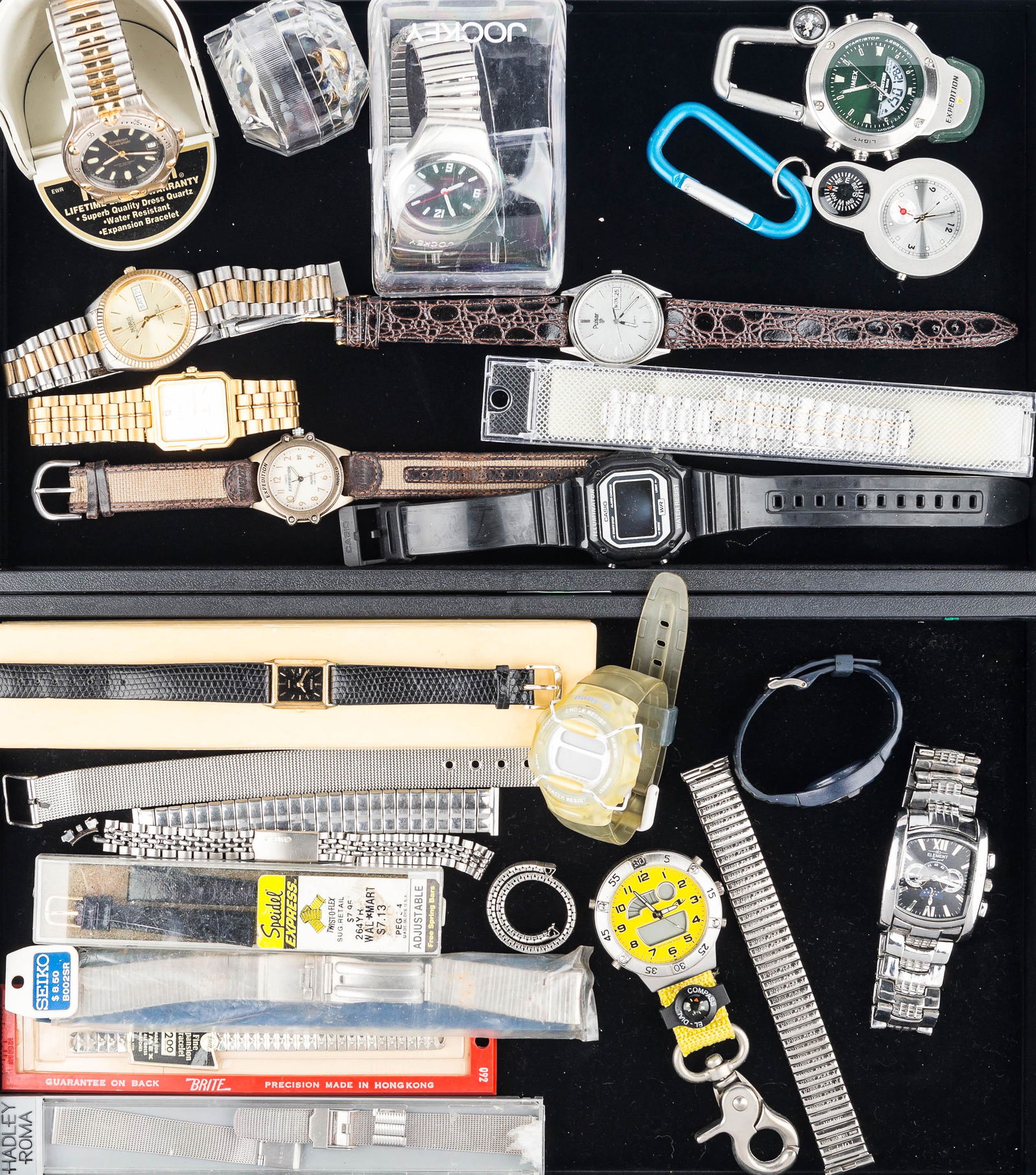 Grouping of Watches: an Armitron Pro All Sport in original display, a Jockey in original pack, gold tone men's Bill Blass, men's Benrus Ultra Steel with day/date, a ladies Pulsar Quartz in case, and other watches and band