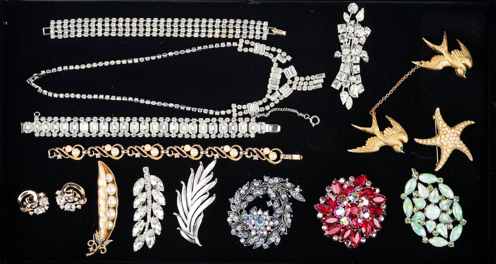 Vintage Trifari and Signed Jewelry: Signed Trifari pea pod brooch, Trifari pearl bracelet and clip earrings with clear rhinestones. Lot also includes signed Weiss red aurora borealis brooch, and several other unsigned brooches.