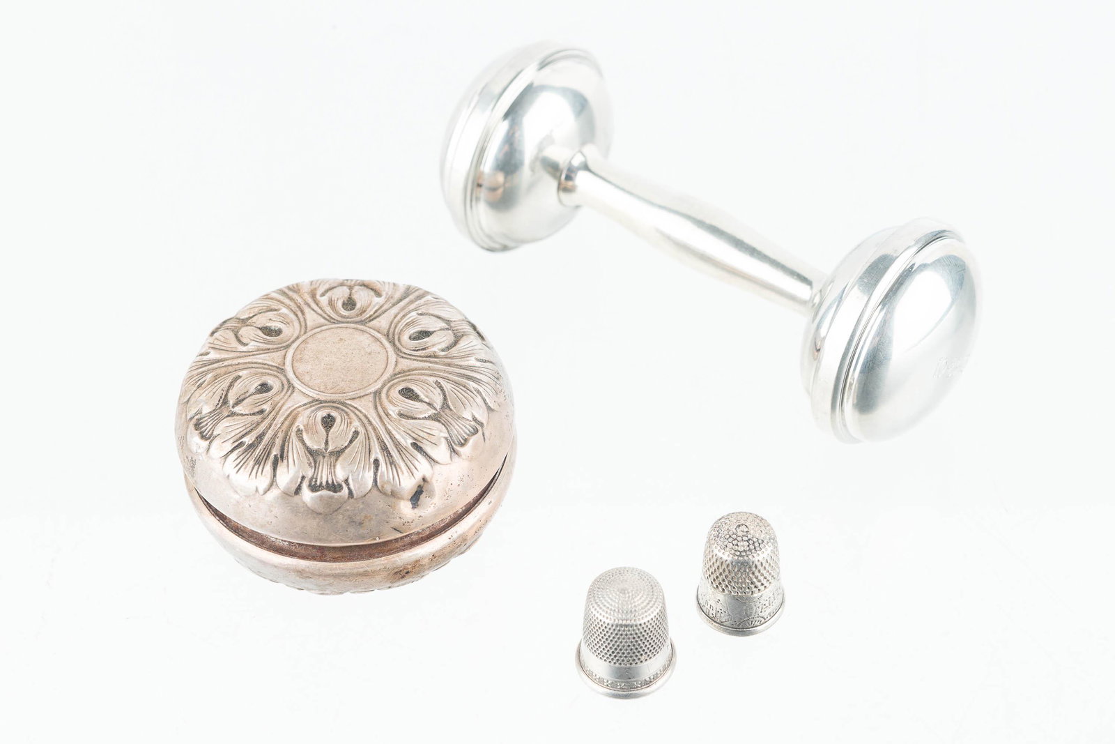 Gorham Sterling Yo-Yo and Coin Silver Rattle: a Victorian decorative yo-yo marked Gorham Sterling Cover 30 Steel Body, un unmarked coin silver rattle date 10/23/15, and two silver thimbles without markings.