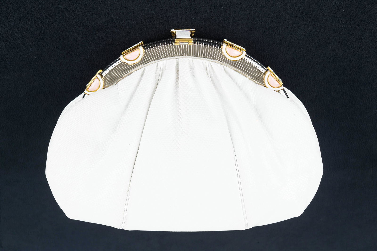 Judith Leiber White Reptile Clutch/Shoulder Purse: This clean white purse is shell shaped with top gathers that go into the hardware which has four pink, white leather, and gold tone accents plus matching clasp. The body is constructed of 3 pieces of
