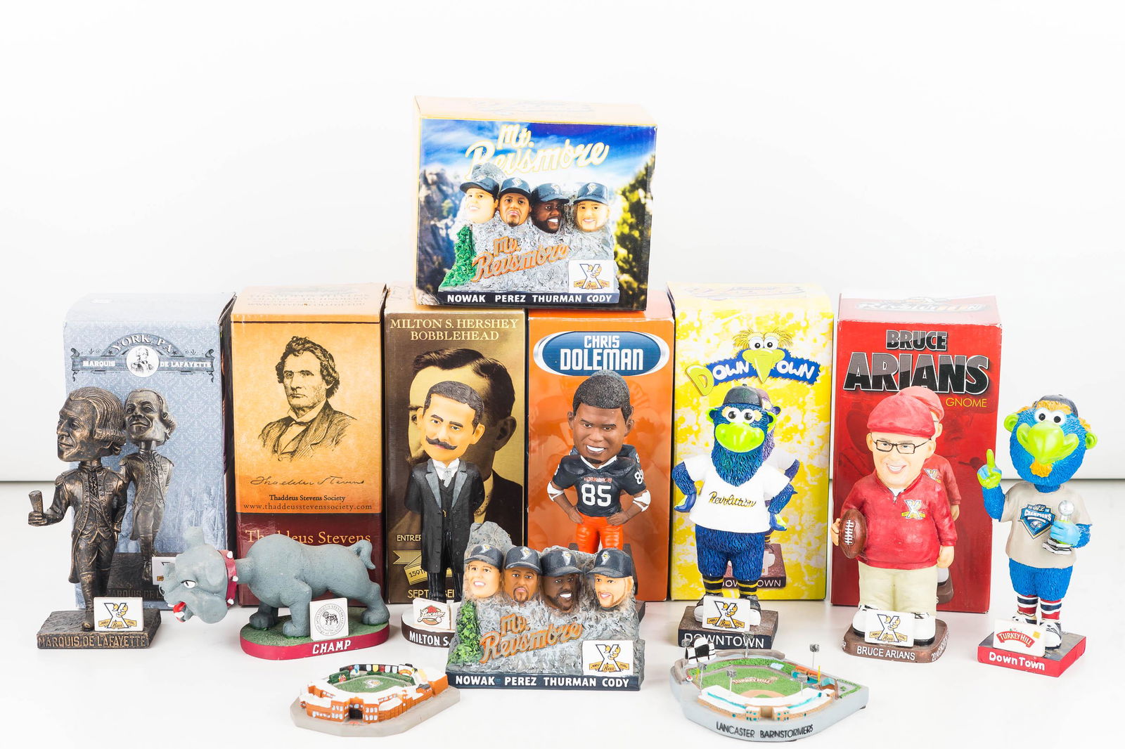 York & Lancaster PA Baseball Bobbleheads: 5 York Revolution game handout promo bobble heads (Bruce Arians football coach, 2 Mascots, Marquis De Lafayette), plus a miniature size stadium and a Mt. Rushmore-like figure, all York Revs. Also a Th