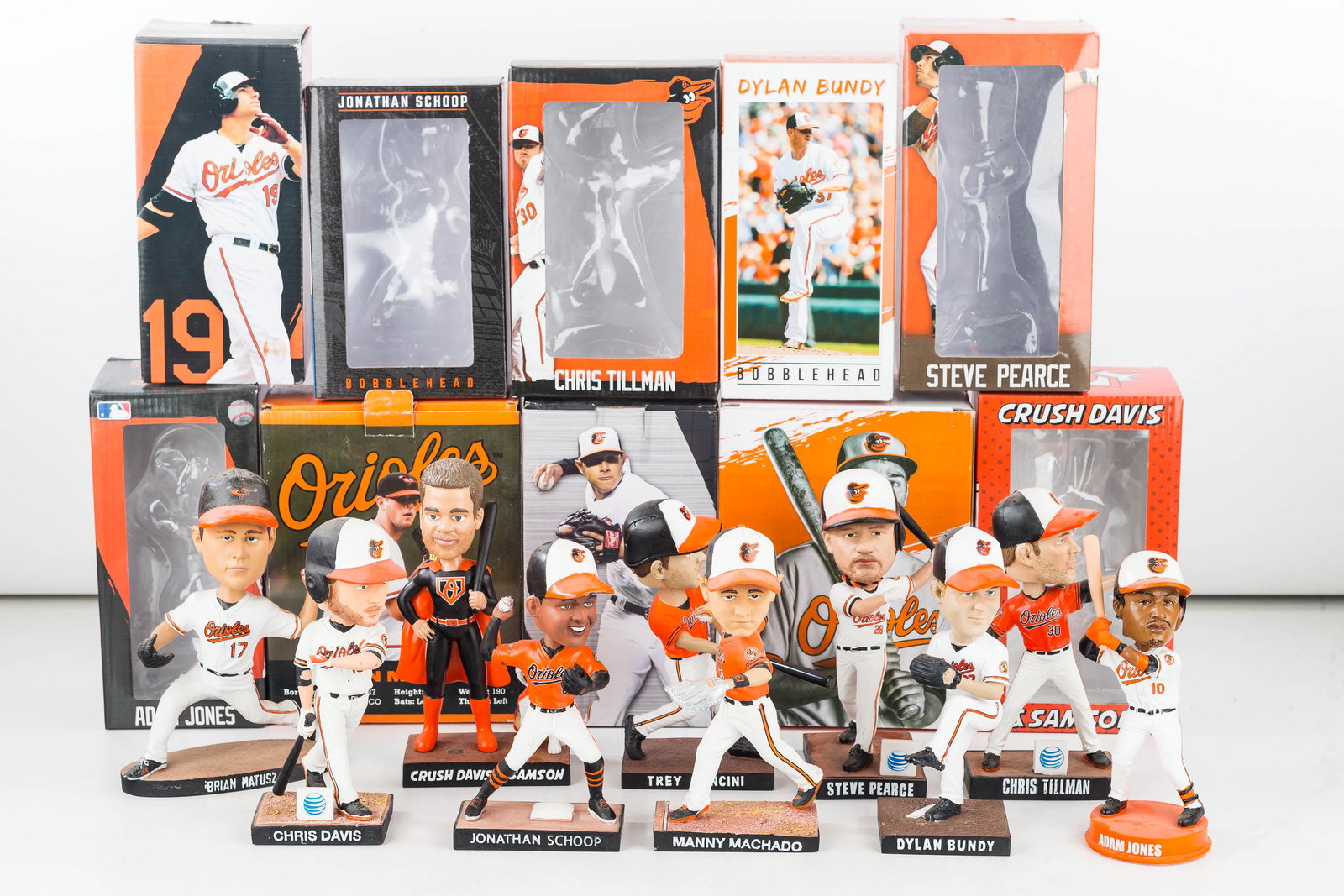 10 Baltimore Orioles Bobbleheads: 10 Baltimore Orioles game handout promo bobble heads. (2 Chris Davis, Trey Mancini, Manny Machado, Jonathan Schoop, Adam Jones, Dylan Bundy, Chris Tillman, Bryan Matusz, and Steve Pearce) 10 boxes to 