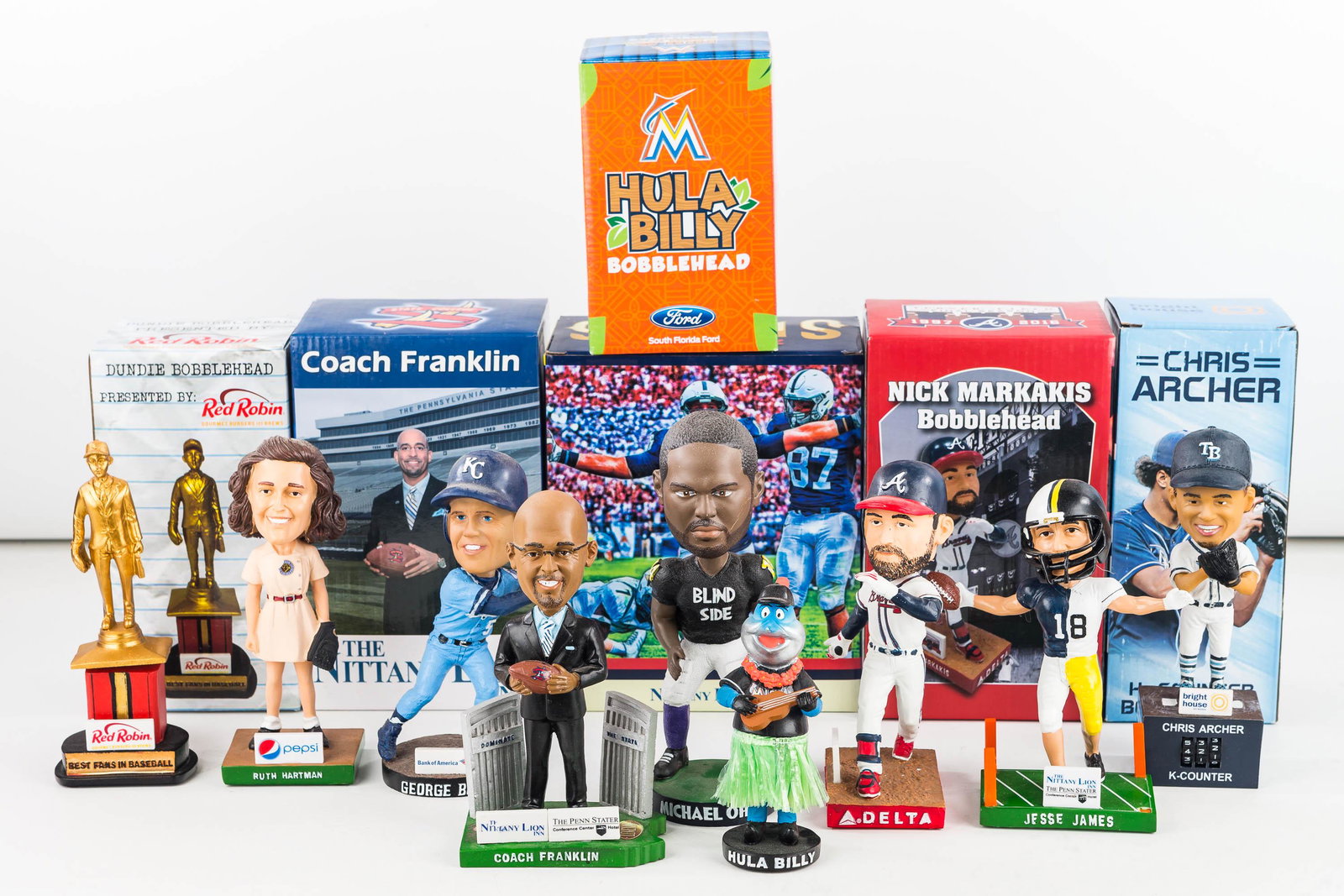 MLB, NFL, College, and Minor League Bobbleheads: 9 game handout promo bobble heads. (Nick Markakis, Chris Archer, George Brett, Marlins Mascot (instrument top broken), Ruth Hartman, Jesse James (1 pylon disconnected), Michael Oher, James Franklin, a