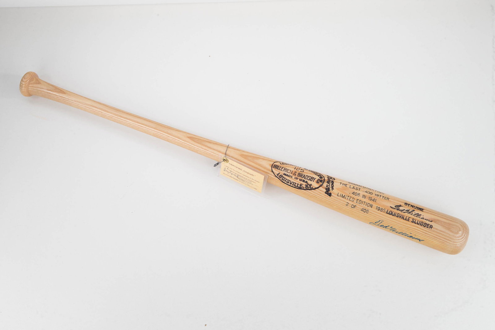 Ted Williams Autograph Louisville Slugger 125 Bat: Signed Ted Williams Louisville Slugger 125 pine bat is in excellent condition with a laminated C.O.A. from Notary Public Henry Lipschutz. It is a 1985 limited edition numbered 2 of 406 commemorating t