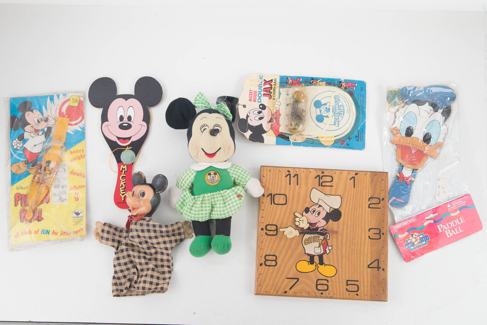Vintage and Contemporary Disney Grouping: Lot includes vintage Mickey Mouse hand puppet, Knickerbocker Minnie Mouse doll, Mickey Mouse punch bag pre-SKU 1960s, Mickey Mouse double Jax set by Chemtoy with SKU, Mickey Mouse paddle ball marked T