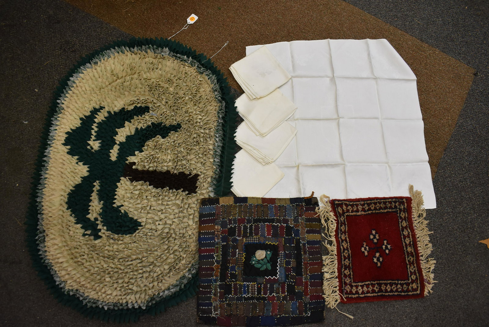 Victorian Quilt Square, 1924 Linens, Rug: Victorian quilt square with beadwork and central flower (rose) and leaf motif with silk pieces and wool back approx 15" square, five 1924 damask linen napkins with Ulster Pavilion British Empire Exhib