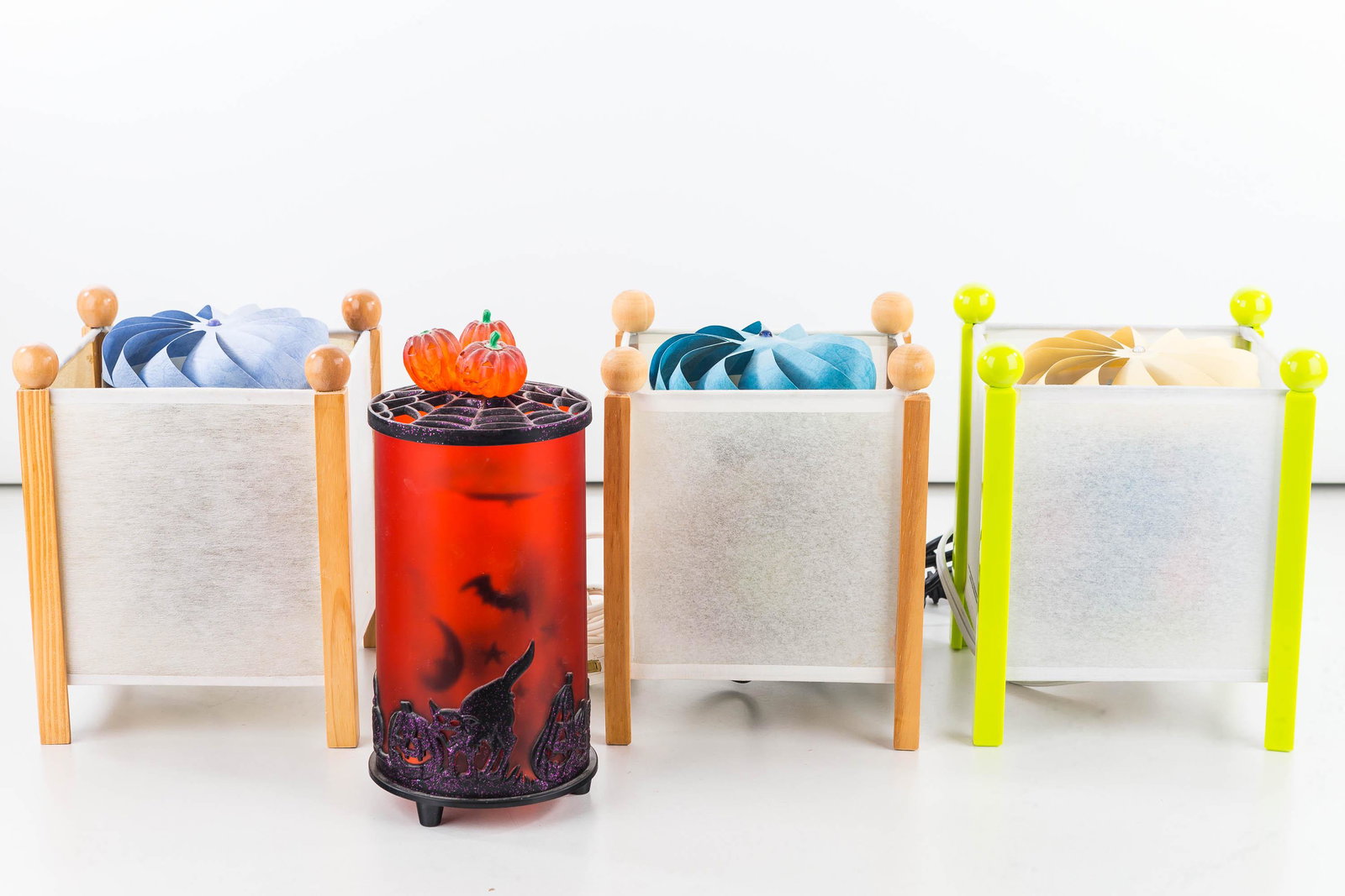 Four Contemporary Motion Lamps: Three are rice paper with various scenes on spinners. One is plastic with a Halloween motif.