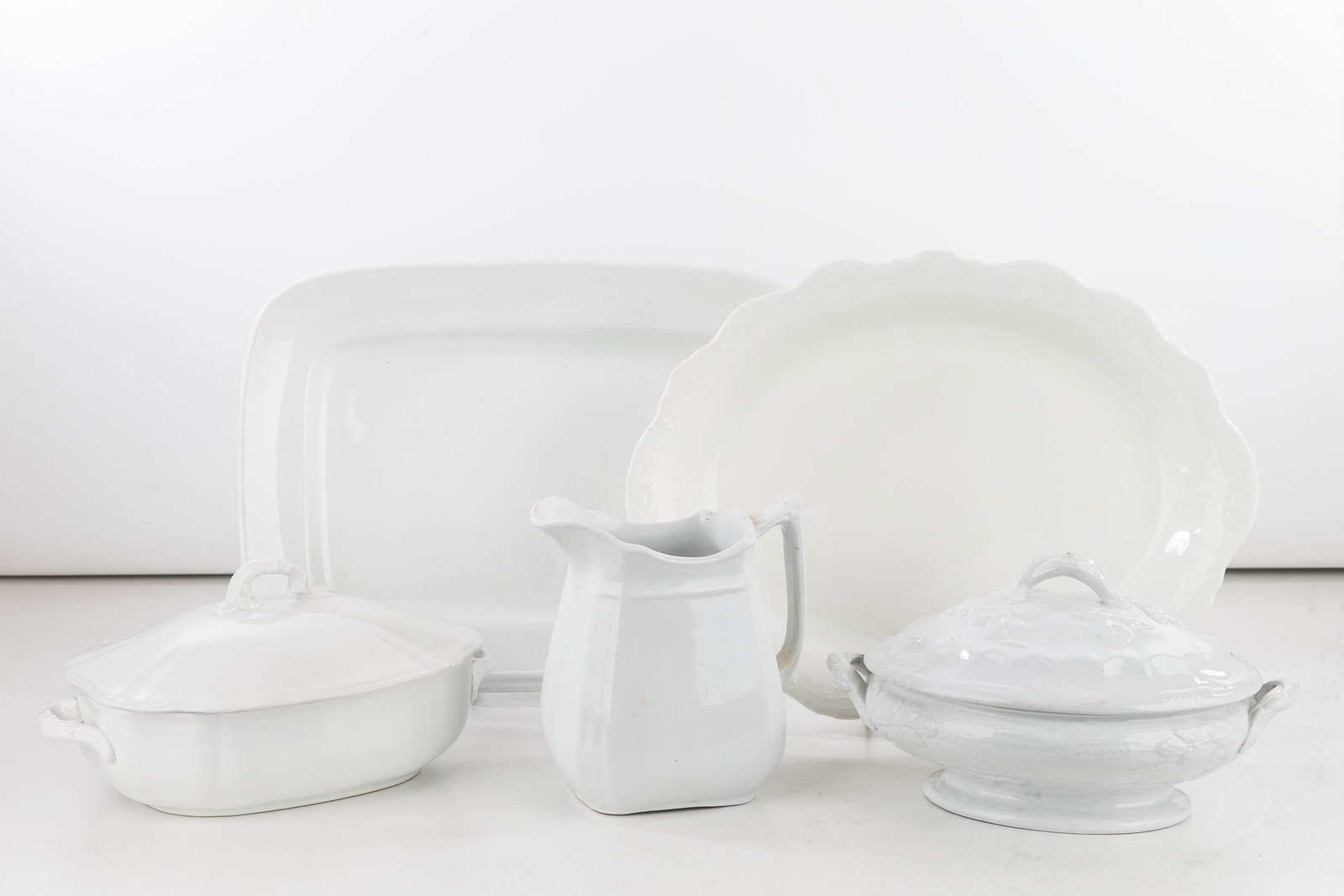 Collection of White Ironstone, 19th C: Lot includes a covered vegetable with a berry pattern and early Meakin stamp on bottom, geometric covered vegetable with Alfred Meakin stamp on bottom, a rectangular Meakin meat platter, a geometric M