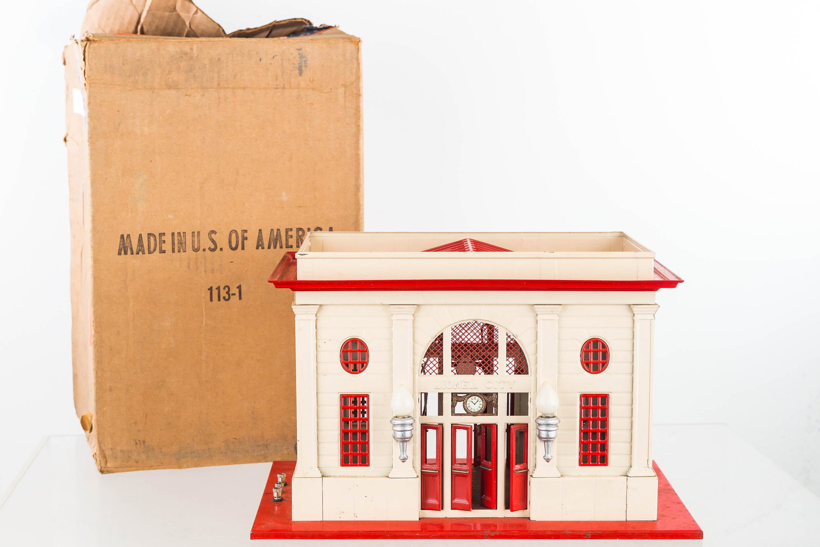 Vintage Tin Lionel City Train Station with Box: Item measures approximately 9"H x 13.5W x 9"D at base. It has a controller switch on roof, doors on front and back,, marked No 115 Station Made by the Lionel Corporation NY US of America. Item comes w
