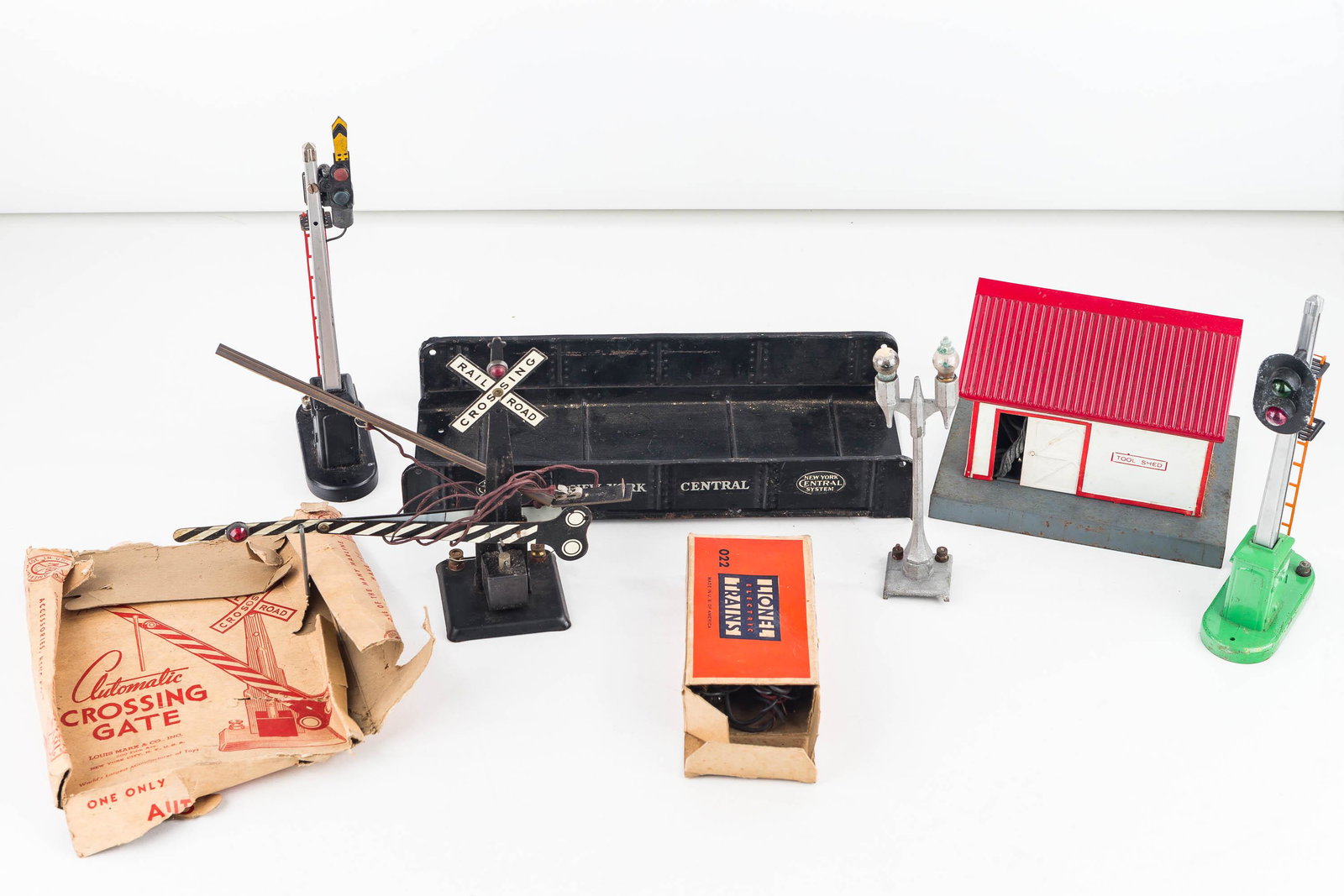 Lionel and Other Train Accessories: Lot includes 2 train crossing lights with metal bodies and ladder, a Marx automatic crossing gate, an American Flyer metal tool shed with plastic roof ad loose side (retains wire), and a metal double 