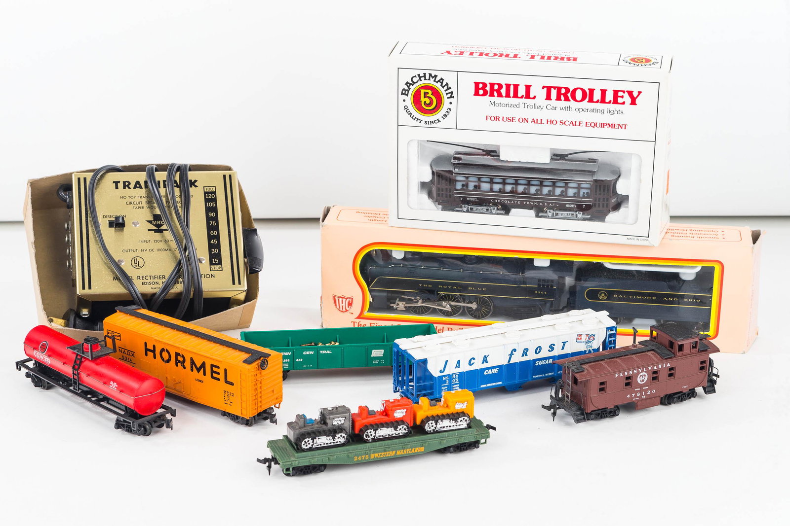 HO Gauge Train and Accessories: Lot includes an IHC HO Gauge Royal Blue Baltimore & Ohio Railroad engine and tender new in box, a Bachman motorized brill trolley, a power pack and various train cars.
