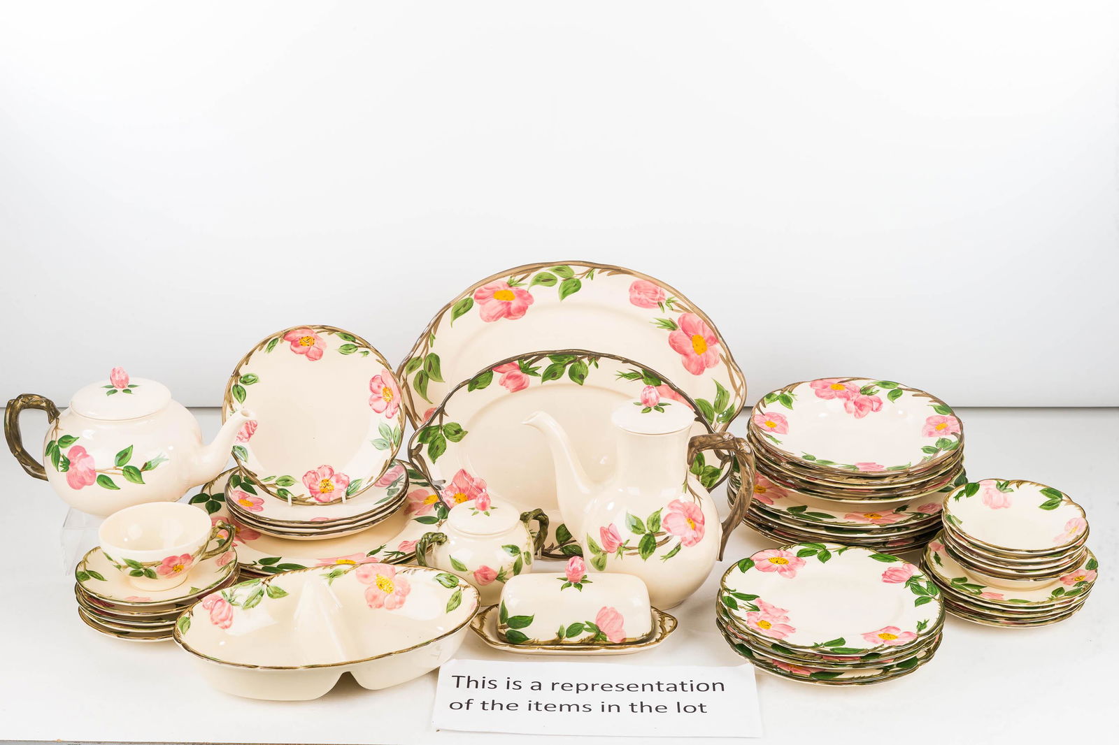 Franciscan Desert Rose China Service: Lot includes 9 dinner plates, 10 salad plates, 15 cups and saucers, 2 teapots, 2 meat platters, 10 soup plates, covered butter, divided dish, and related. Made in England back stamp.