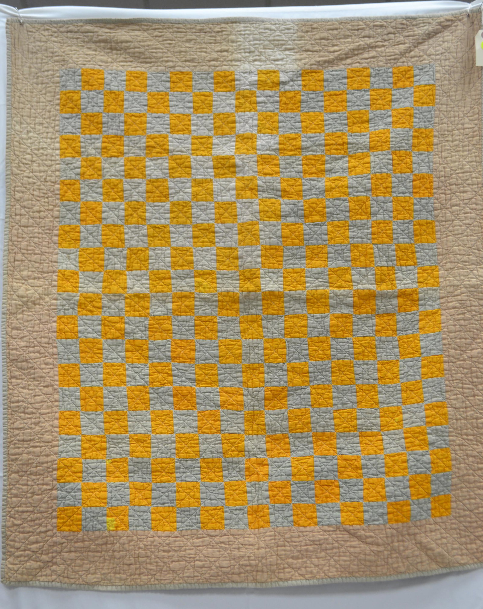 Early 20th Cent. Crib Quilt: Measures approx. 43" x 36". Child's quilt is early machine stitched (possibly treadle) and the back shows wear (thread bare in many areas). Tan/Peach Color/Pink border. Brown patterned material on bac