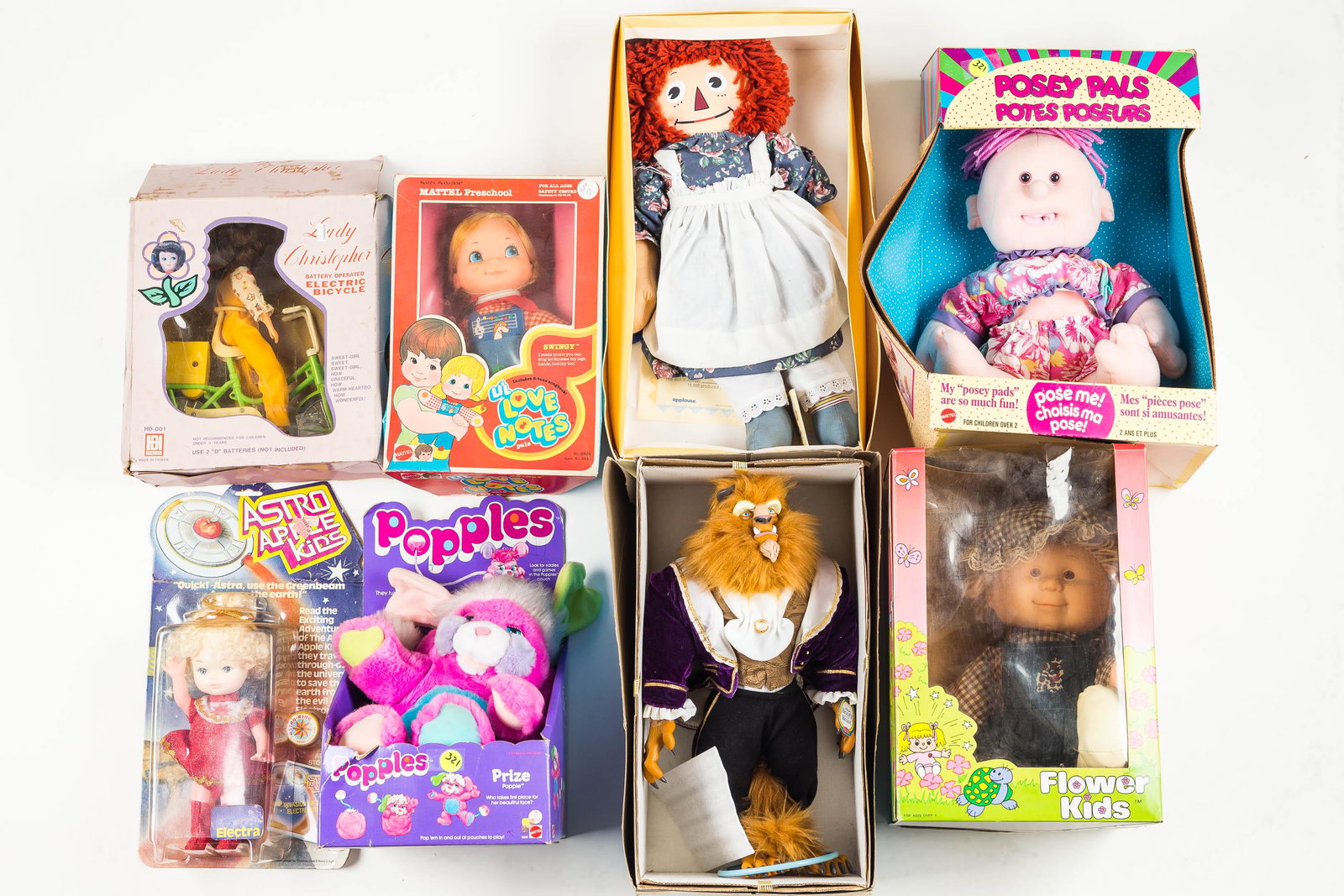 Mixed Doll Grouping: There are seven pieces including Raggedy Ann in box, Lady Christopher electric bicycle, Flower Kids doll and others. All in original package.