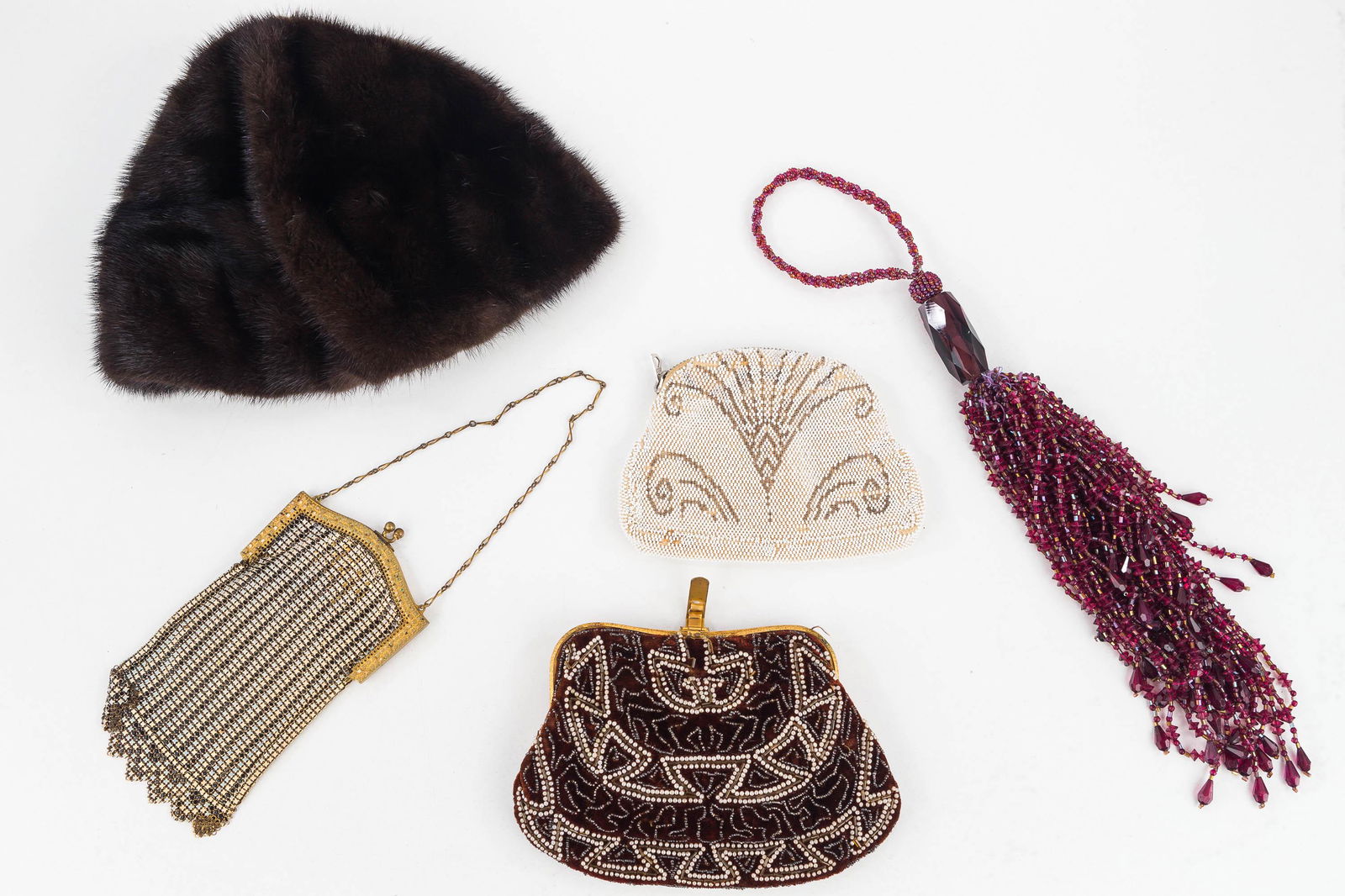 Vintage Purses and Fur Cap: Including Whiting & Davis metal mesh purse, white beaded clutch showing minor wear, brown beaded clutch, and a beaded fly whisk. Also includes a fur cap