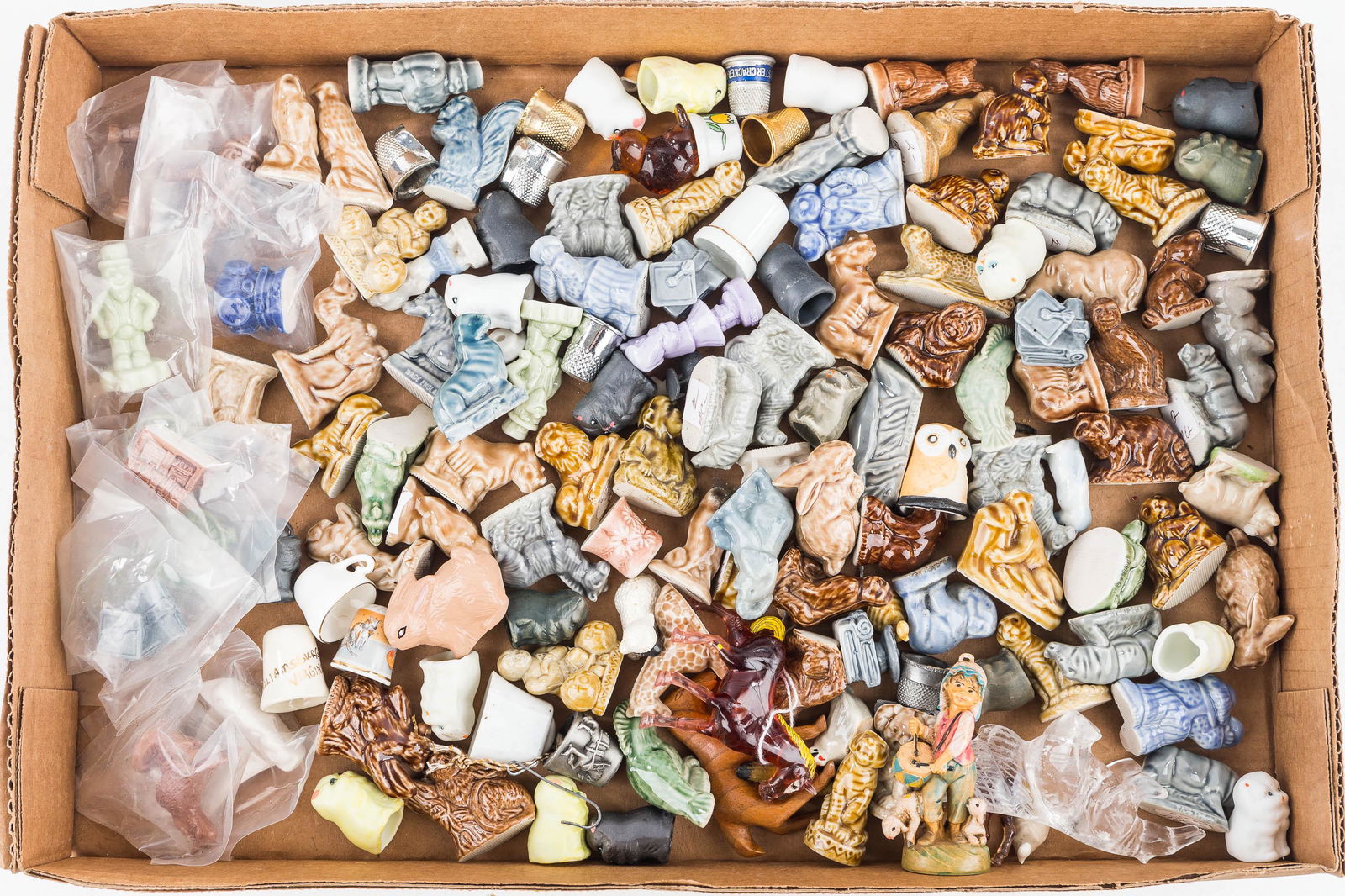 Collection of Wade English Figurines: Approx. 60 wade figurines, some still in bags. Lot also includes unrelated thimbles and figures.